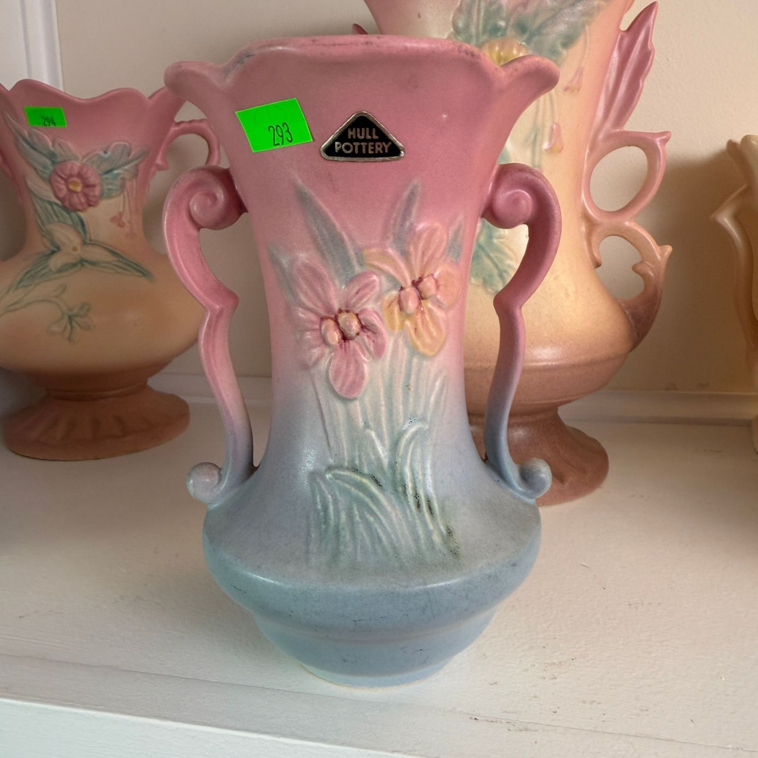 Lot #293, Hull pottery iris vase with sticker, hairline crack on back, 7"