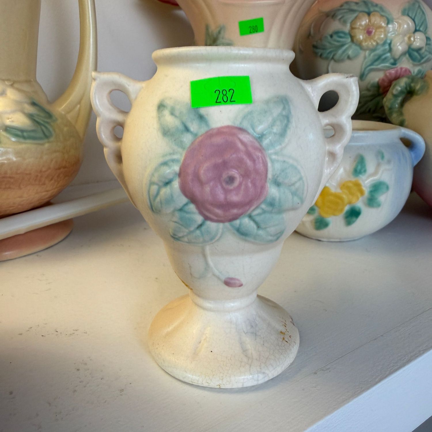 Lot #282, Hull pottery open rose vase with looped handles, a few chips, 4 1/4"