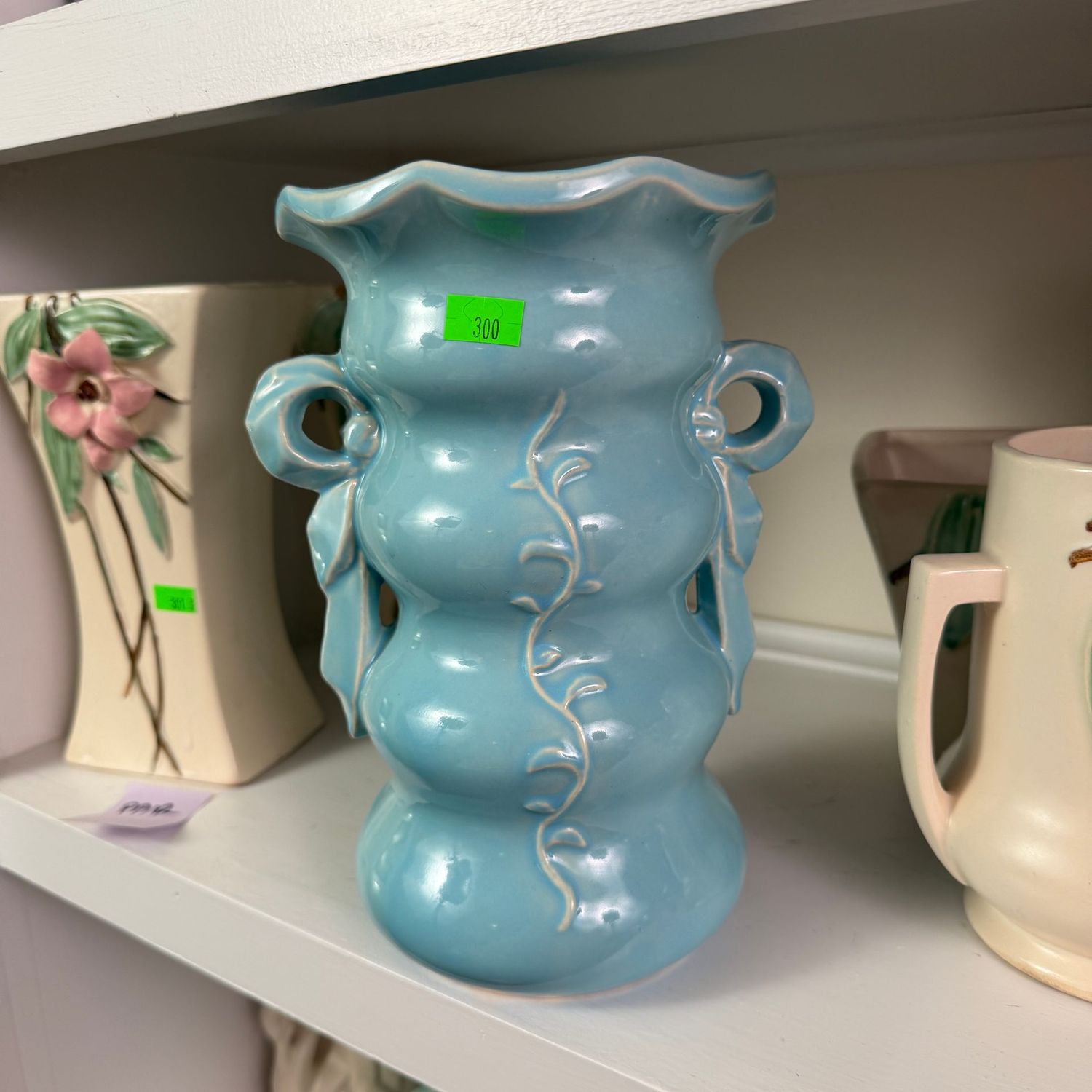 Lot #300, McCoy pottery blue vase with bow handles, 8"
