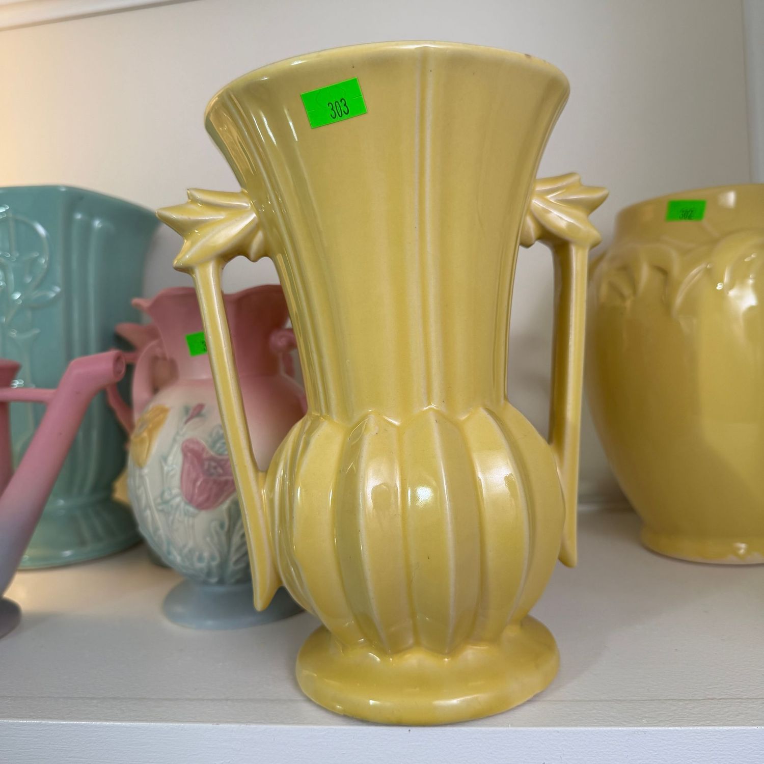 Lot #303, McCoy pottery, yellow deco, double-handled vase, minor hairline, 7.5 Lot #303, McCoy pottery, yellow deco, double-handled vase, minor hairline, 7.5"