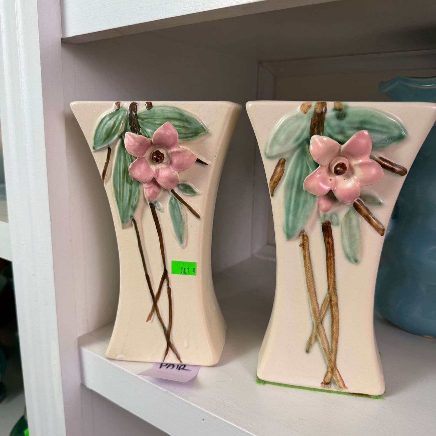 Lot #307, pair of McCoy pottery Blossom Time vases, one has a mild hairline, the other minor chips, 7"