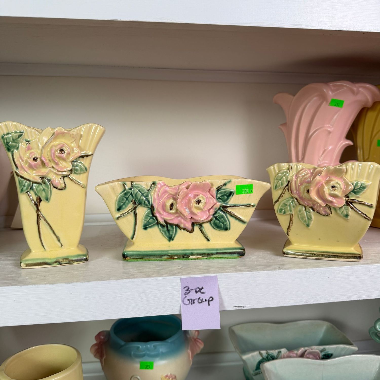 Lot #330, group of yellow McCoy pottery wild rose vase and planters, the tallest is 6.5" & has a chipped rose petal