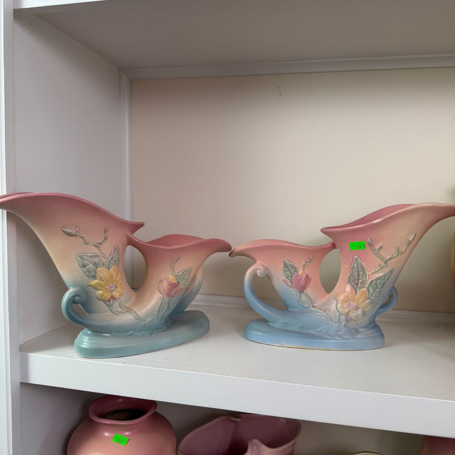 Lot #334, pair of Hull pottery magnolia double cornucopia vases, one has a repaired chip, 12"
