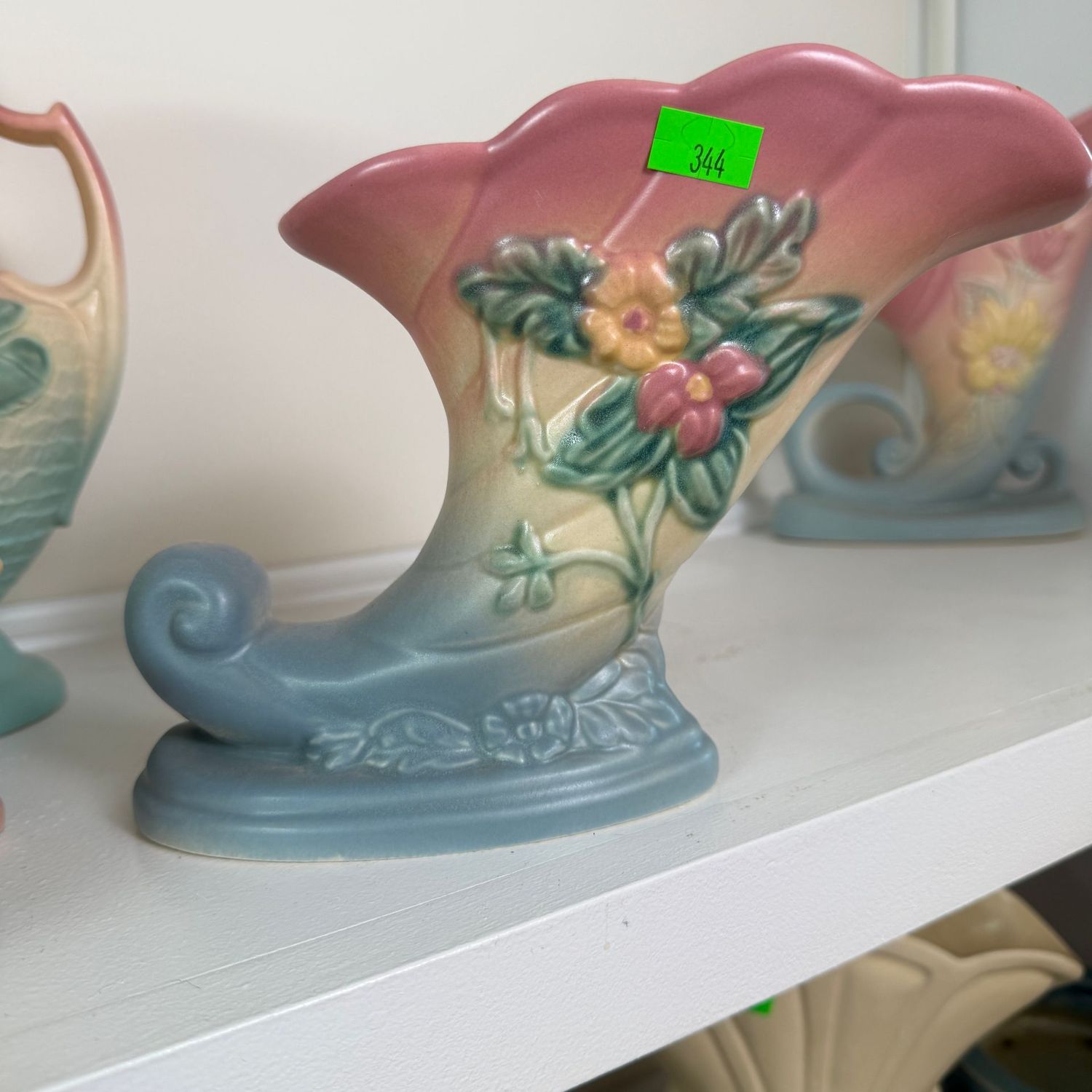 Lot #344, Hull pottery wildflower cornucopia vase, color-repaired chip on base, 7 1/2"