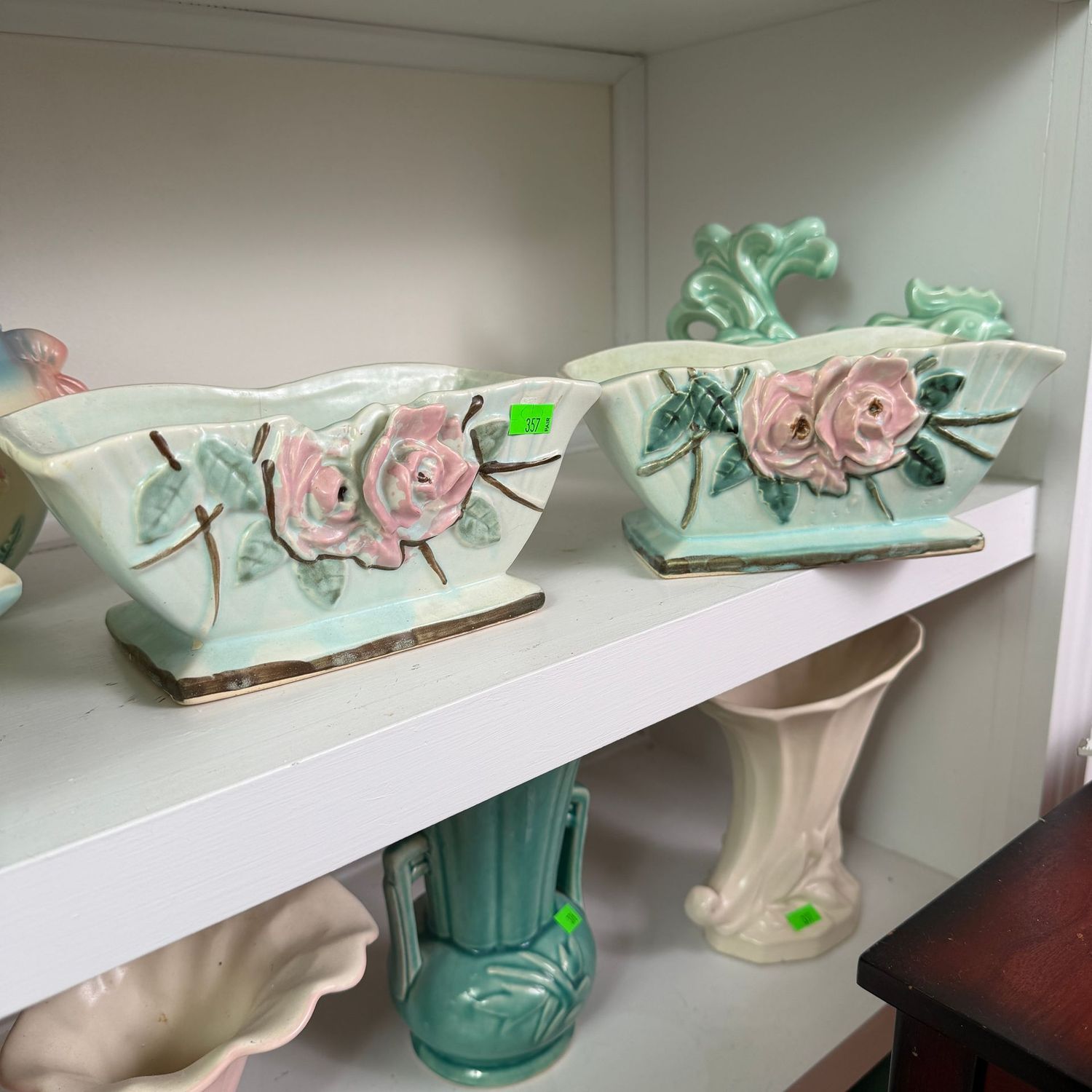 Lot #357, pair of light green, McCoy pottery wildflower planters, one has a minor hairline, 8"W