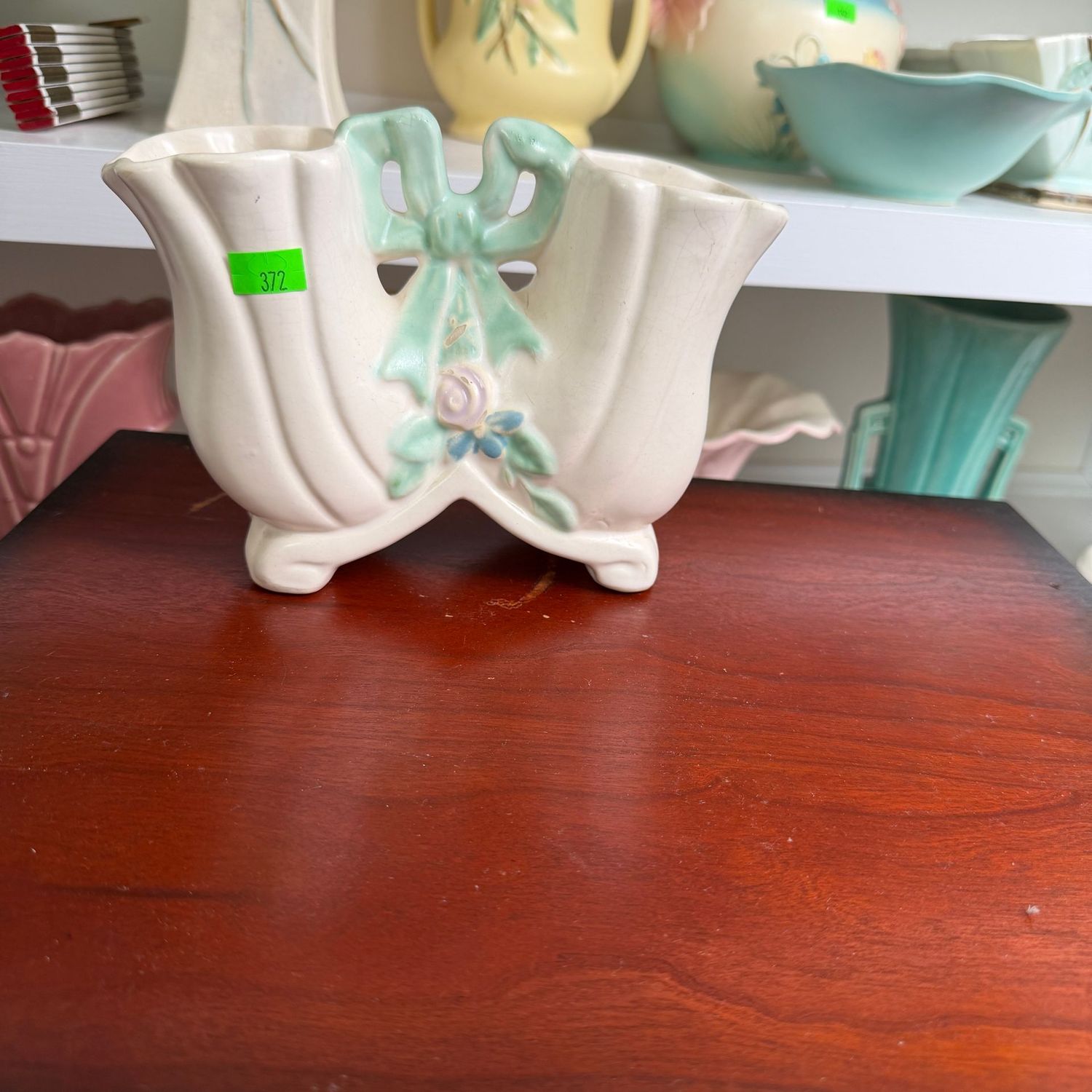 Lot #372, Weller pottery ivory double vase with teal ribbon, 7 Lot #372, Weller pottery ivory double vase with teal ribbon, 7"W x 5.25"H