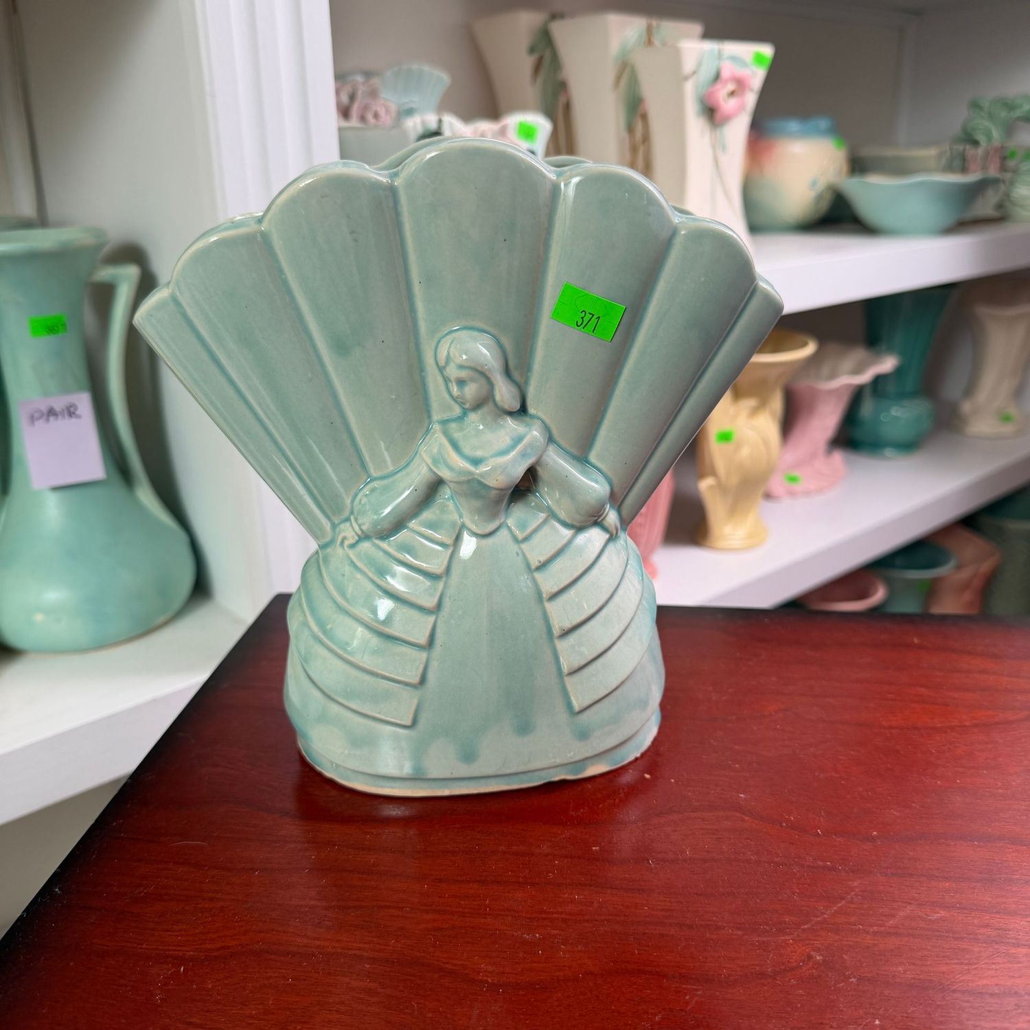 Lot #371, teal pottery 218 mold fan, woman in dress, crinoline vase, 8 1/4"