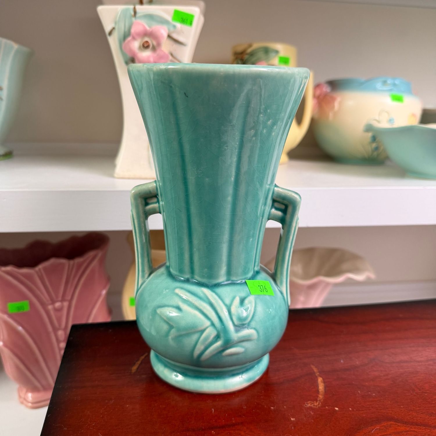 Lot #376, McCoy pottery teal floral deco vase, minor wear/hairline, 8.25"