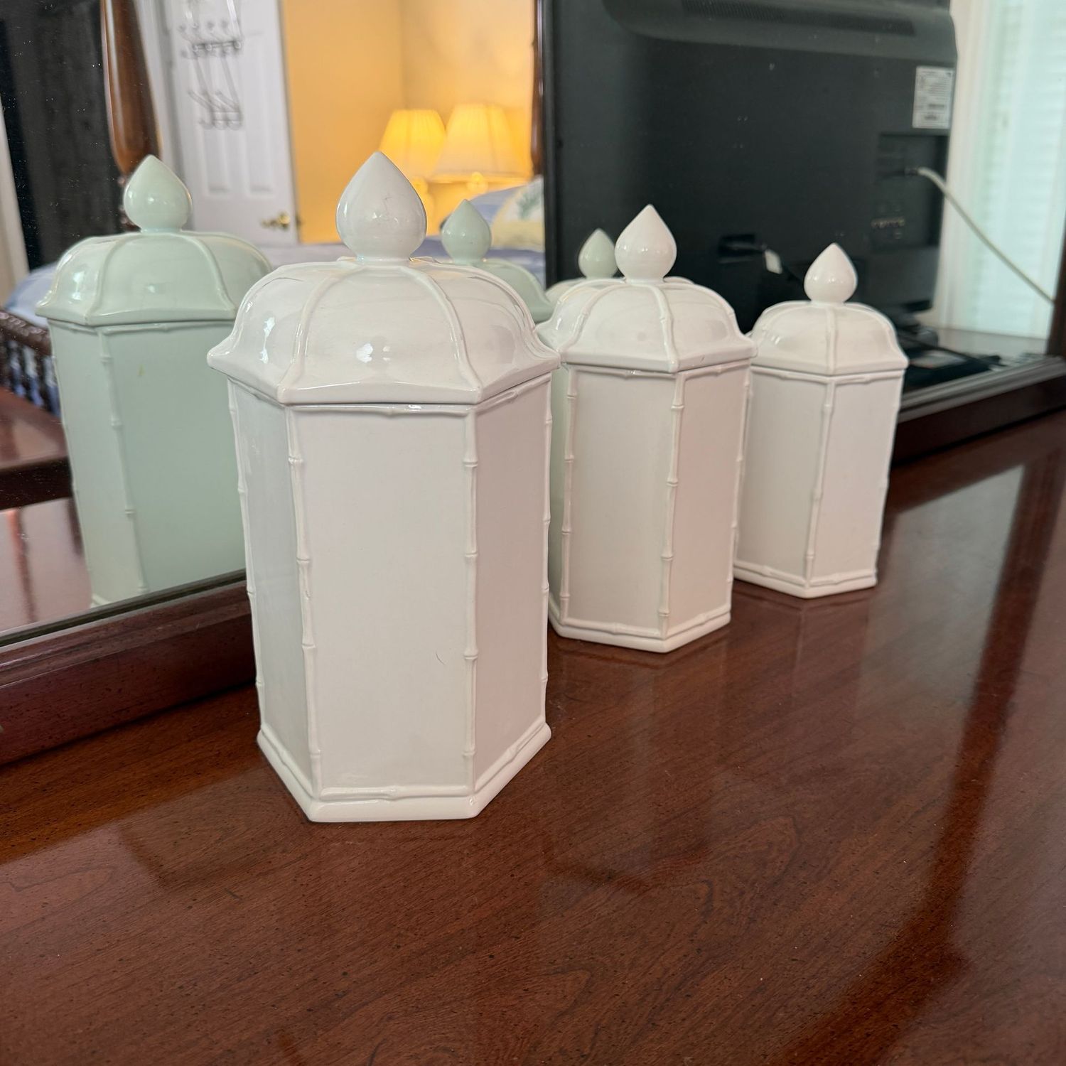 Set of 3 Italian ceramic paneled canisters, the tallest is 12"