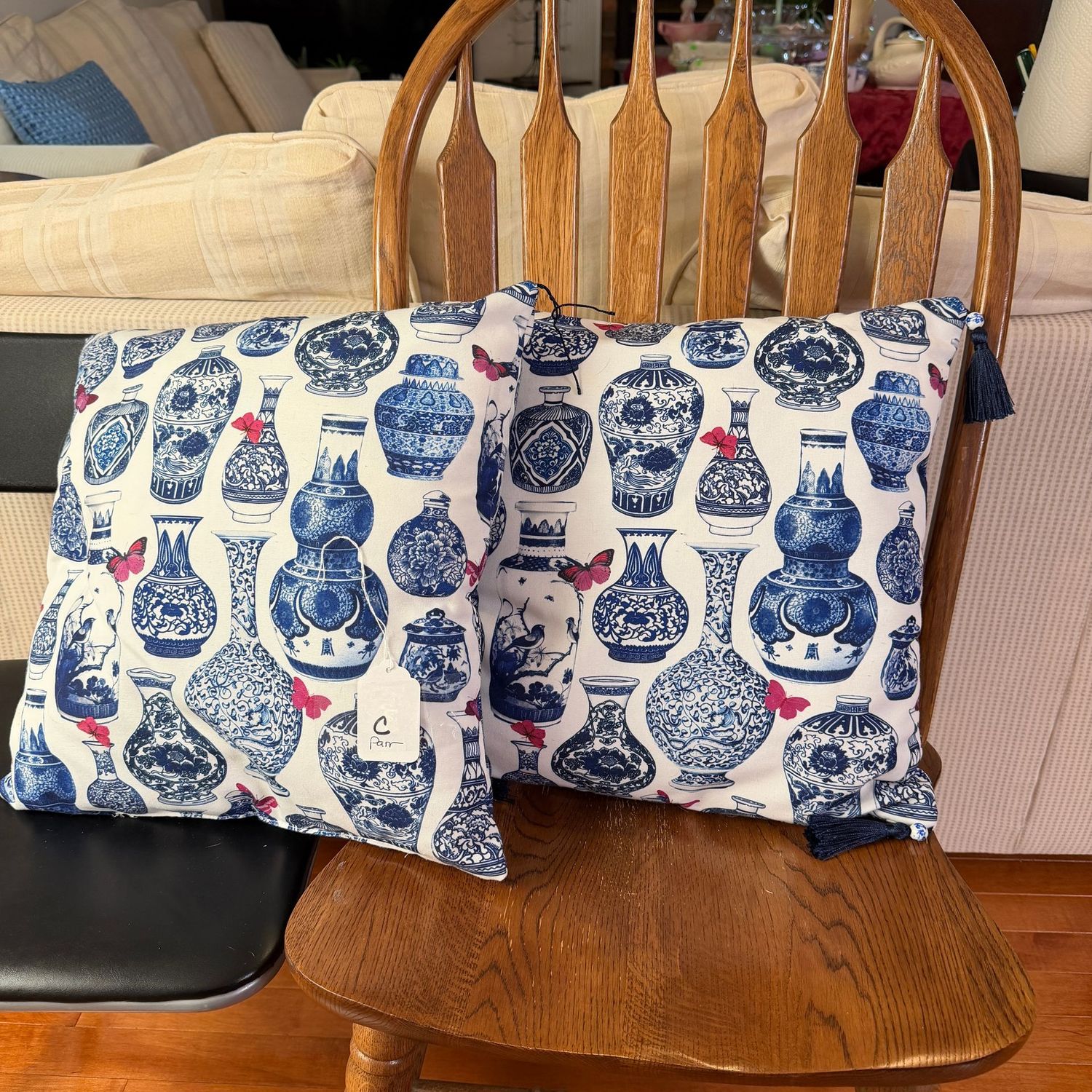 Pillow C - pair of blue and white vase pillows, one is missing 2 tassels, 15"