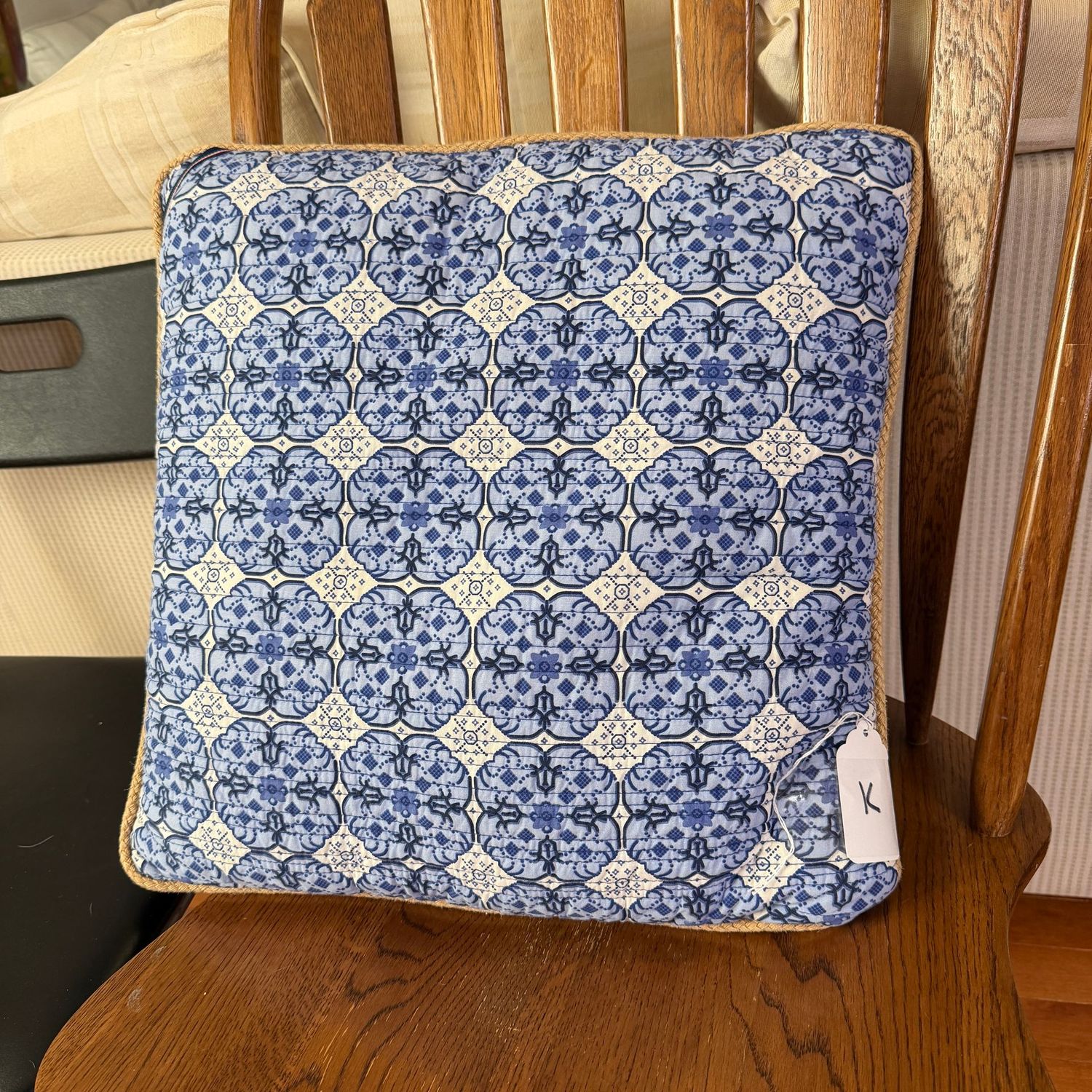 Pillow K - ivory with geometric floral, rope border, minor spot on back, 16"