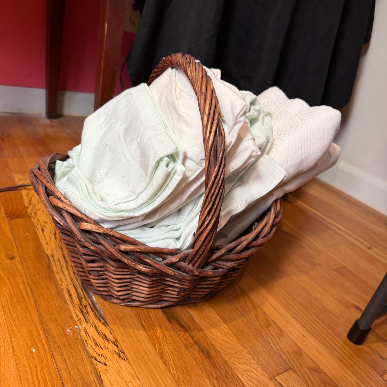 Basket of vintage tablecloths, some napkins, may have some small stains or wear Basket of vintage tablecloths, some napkins, may have some small stains or wear