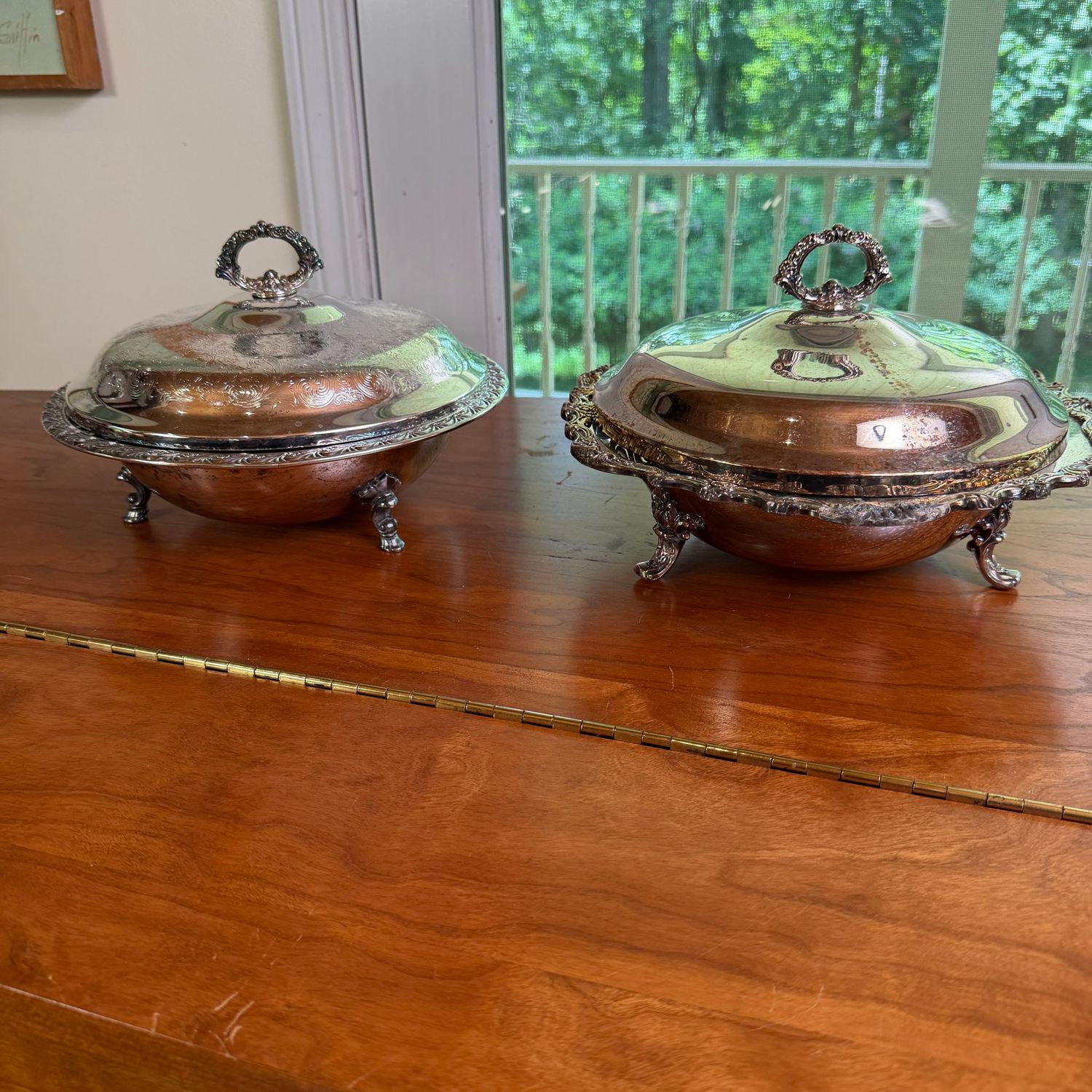 Two silver-plated footed casseroles, glass liners, some wear, 11 Two silver-plated footed casseroles, glass liners, some wear, 11"W