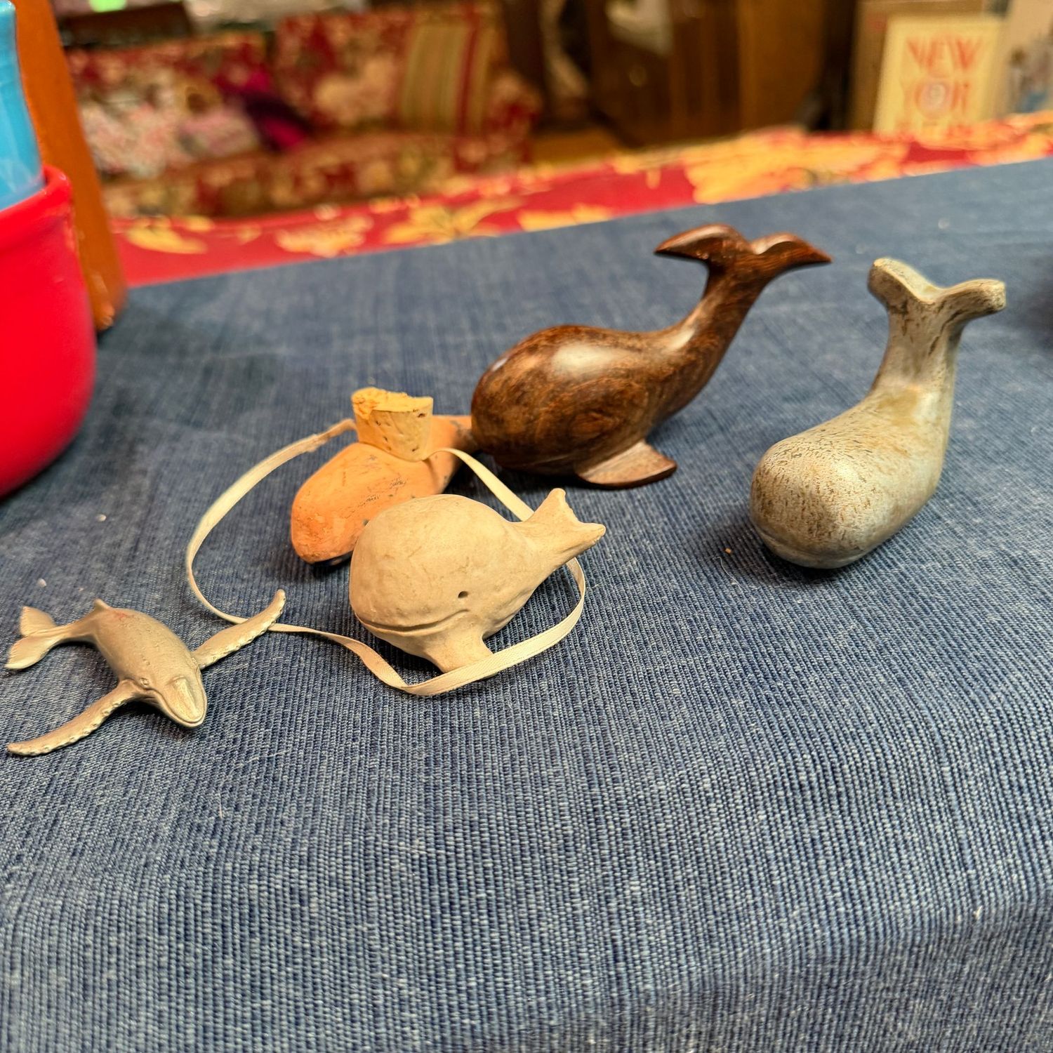 Grouping of small whales, stone, ceramic, wood, and pewter 2-3"