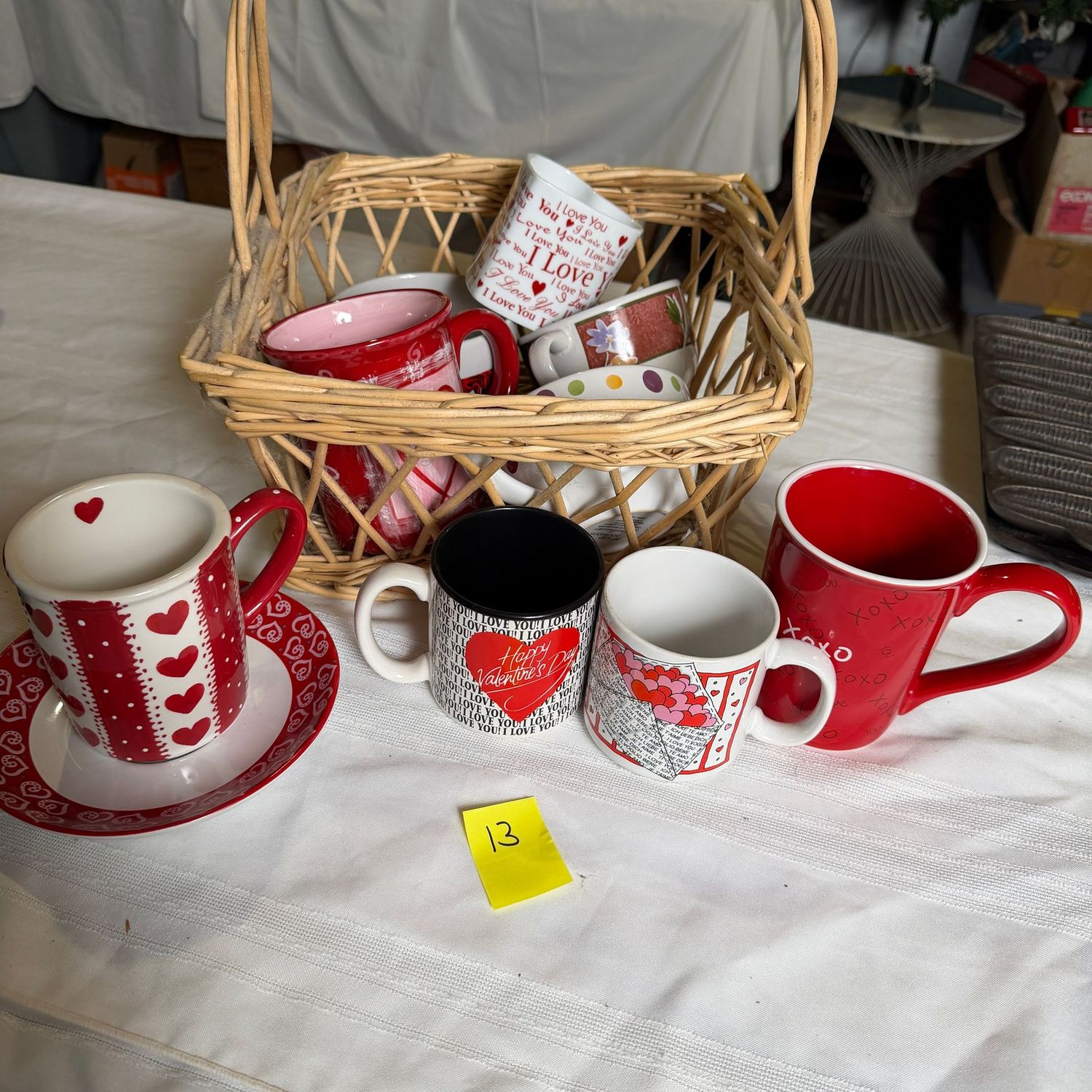 Lot #13, basket of mugs, mostly Valentine's Day-themed Lot #13, basket of mugs, mostly Valentine's Day-themed