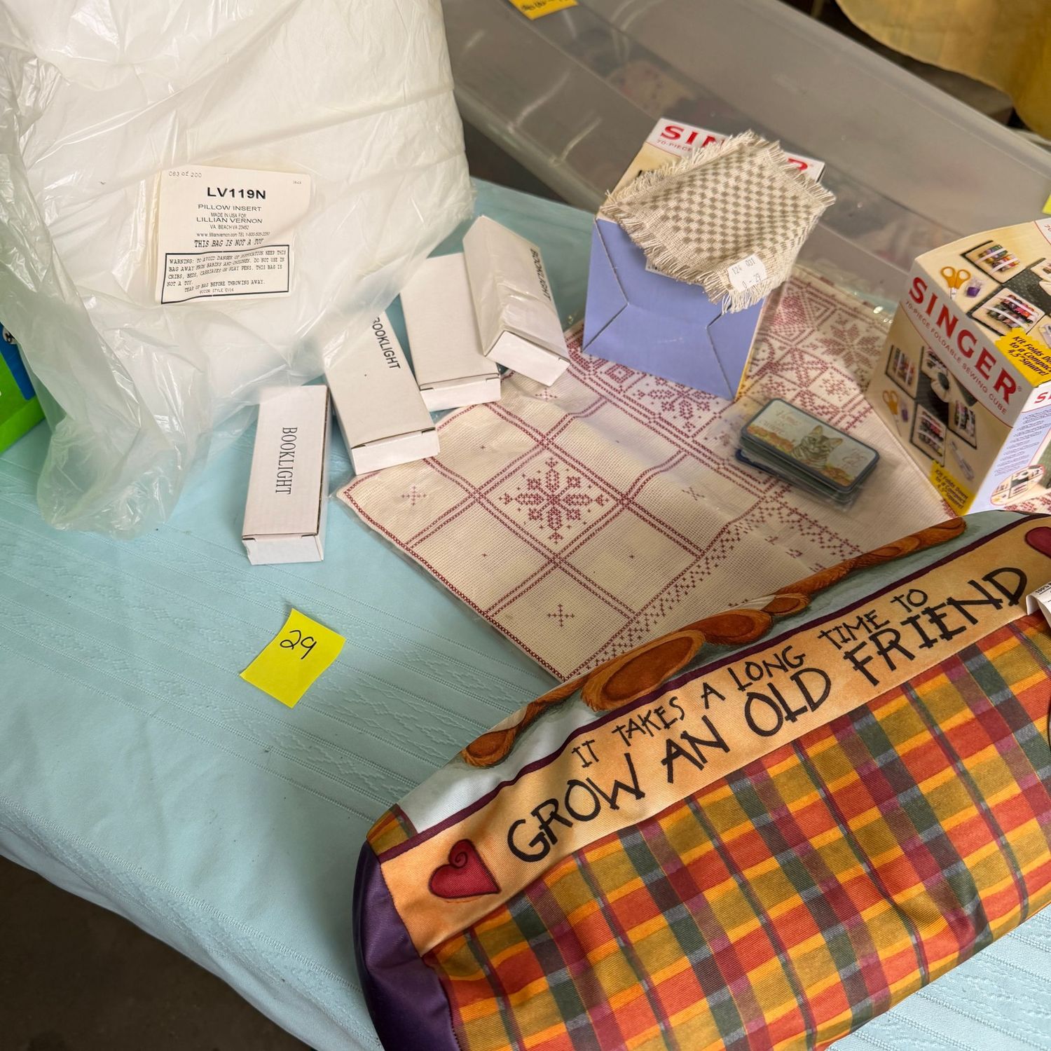 Lot #29, bin with pillow, pillow case, book lights, thread Lot #29, bin with pillow, pillow case, book lights, thread