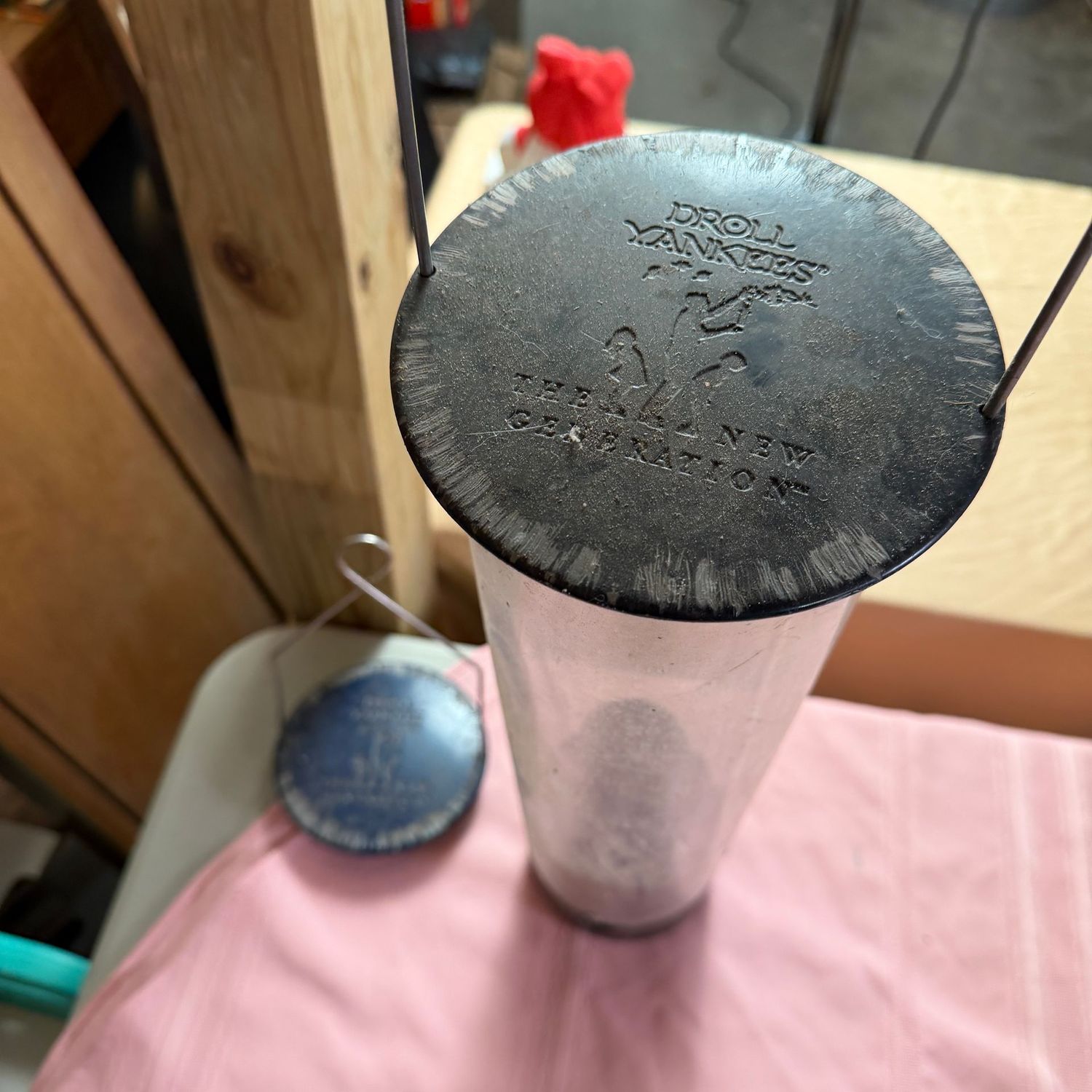 Droll Yankees long bird feeder, some wear, has an extra lid