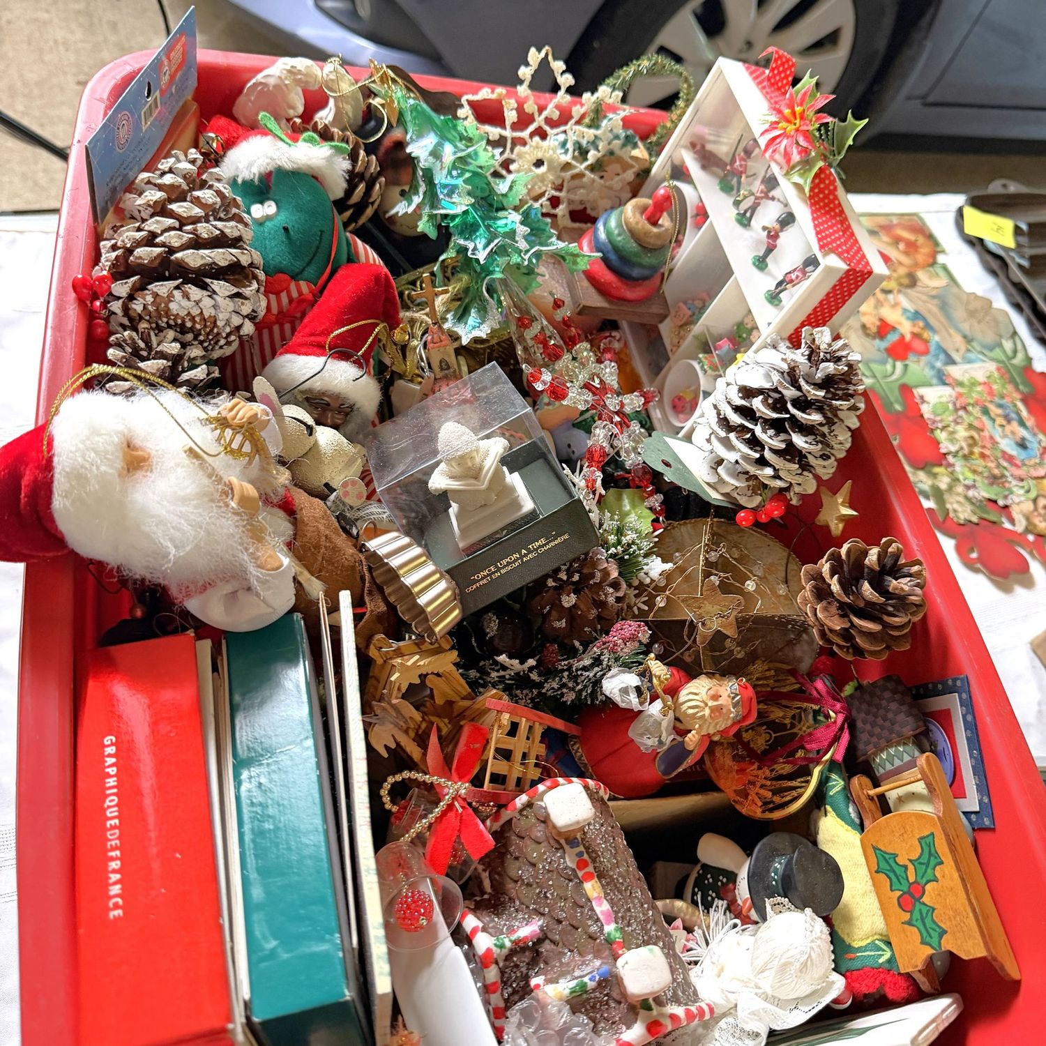 Lot #25, red bin of Christmas decorations, cards, ornaments Lot #25, red bin of Christmas decorations, cards, ornaments