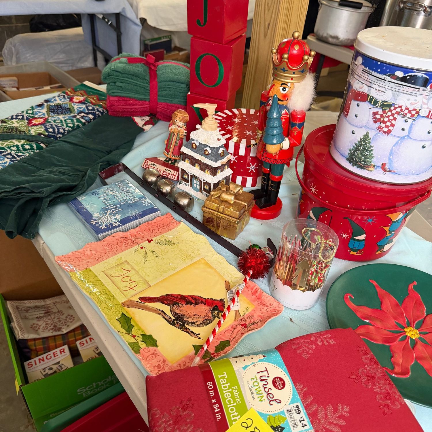 Lot #28, bin of decorative Christmas items, plates, tablecloth, nutcracker, hand towels Lot #28, bin of decorative Christmas items, plates, tablecloth, nutcracker, hand towels