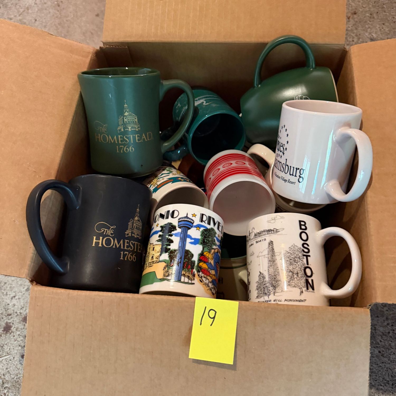 Lot #19, box of mugs, travel-themed Lot #19, box of mugs, travel-themed