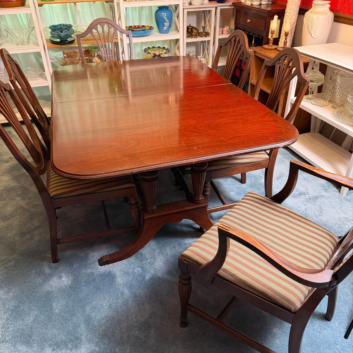 Mahogany dining table and 6 sturdy chairs, trestle leg, some scratches to top, protective pads, does have a leaf & the table is expandable, 60"L x 42"W