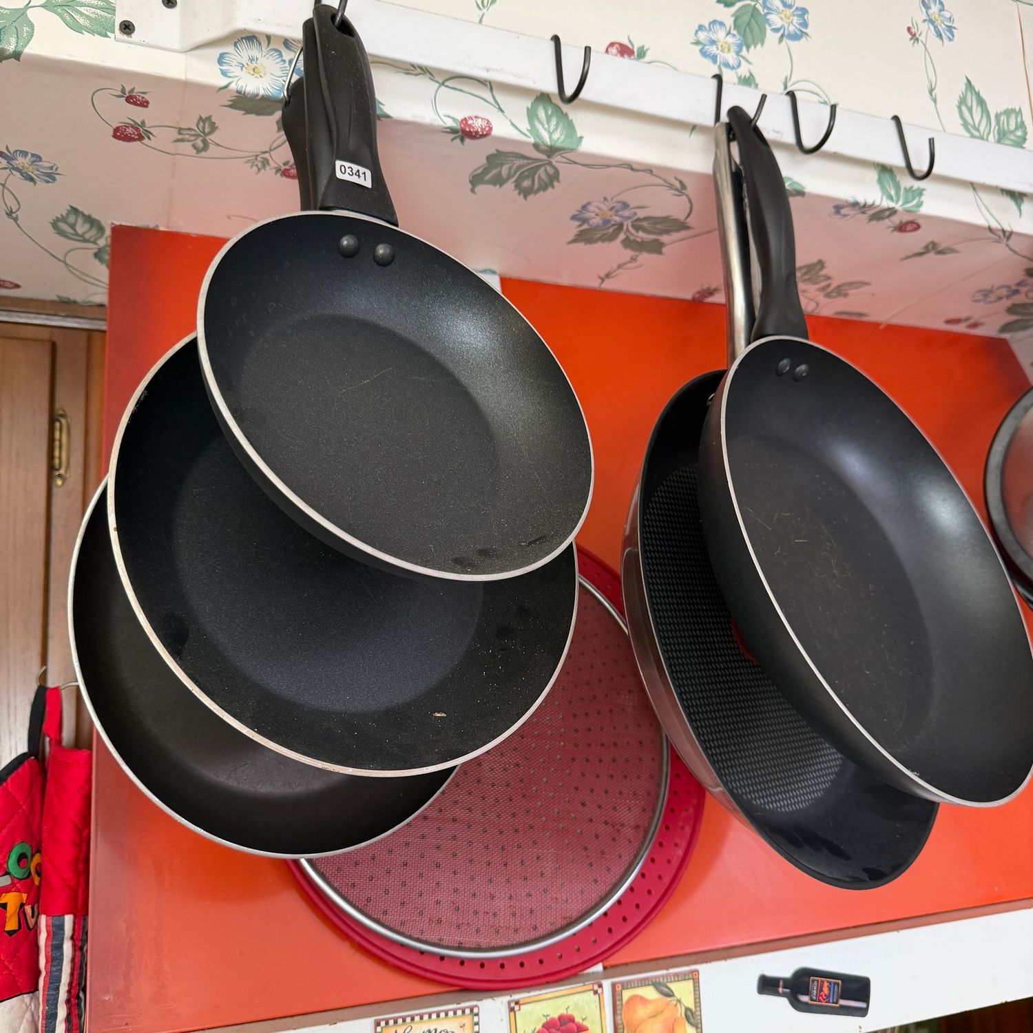 Group of nonstick pans, some wear, splatter screens, the widest pan is 12", S0341