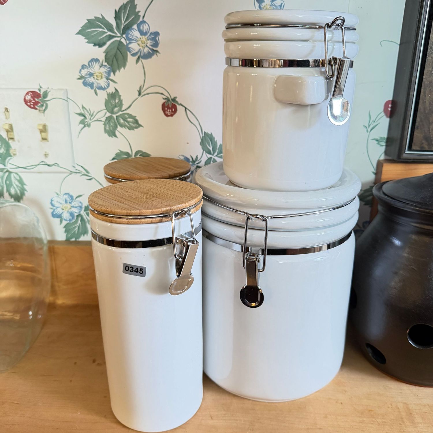 Group of 4 white ceramic canisters, the tallest is 9", S0345