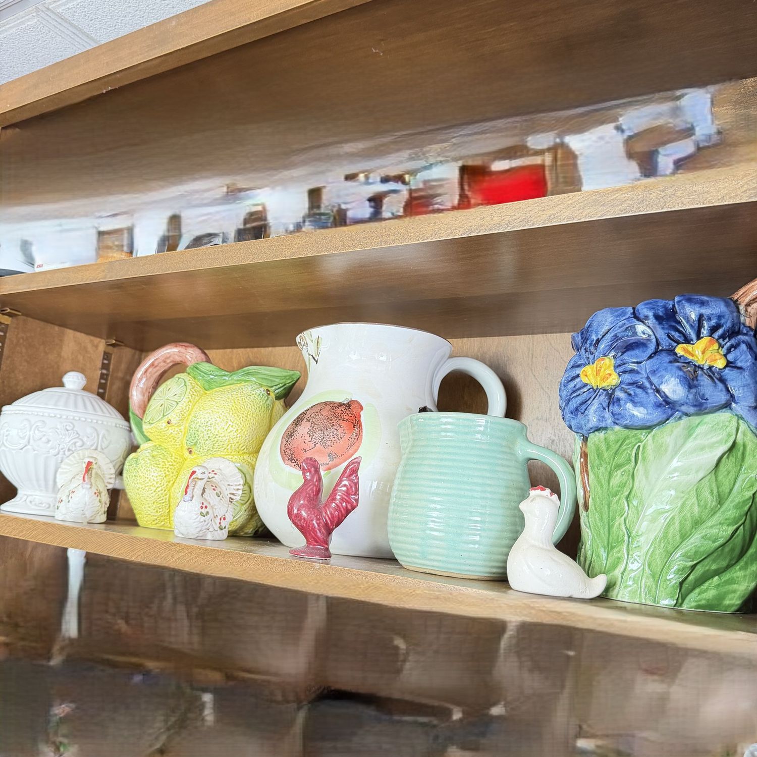 Shelf 2, Group of mostly colorful ceramic pitchers, and a few turkeys, hen, rooster, S0349