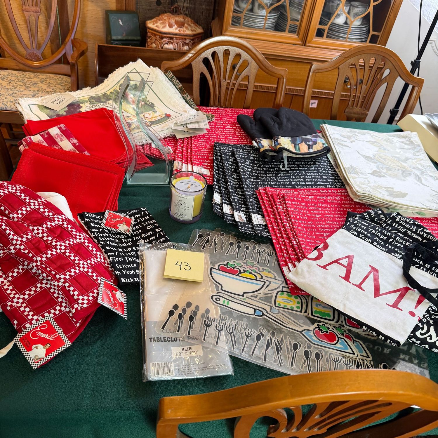 Box Lot (Packed) 43, Large variety of placemats, vase, candle, apron, Emeril items Box Lot (Packed) 43, Large variety of placemats, vase, candle, apron, Emeril items