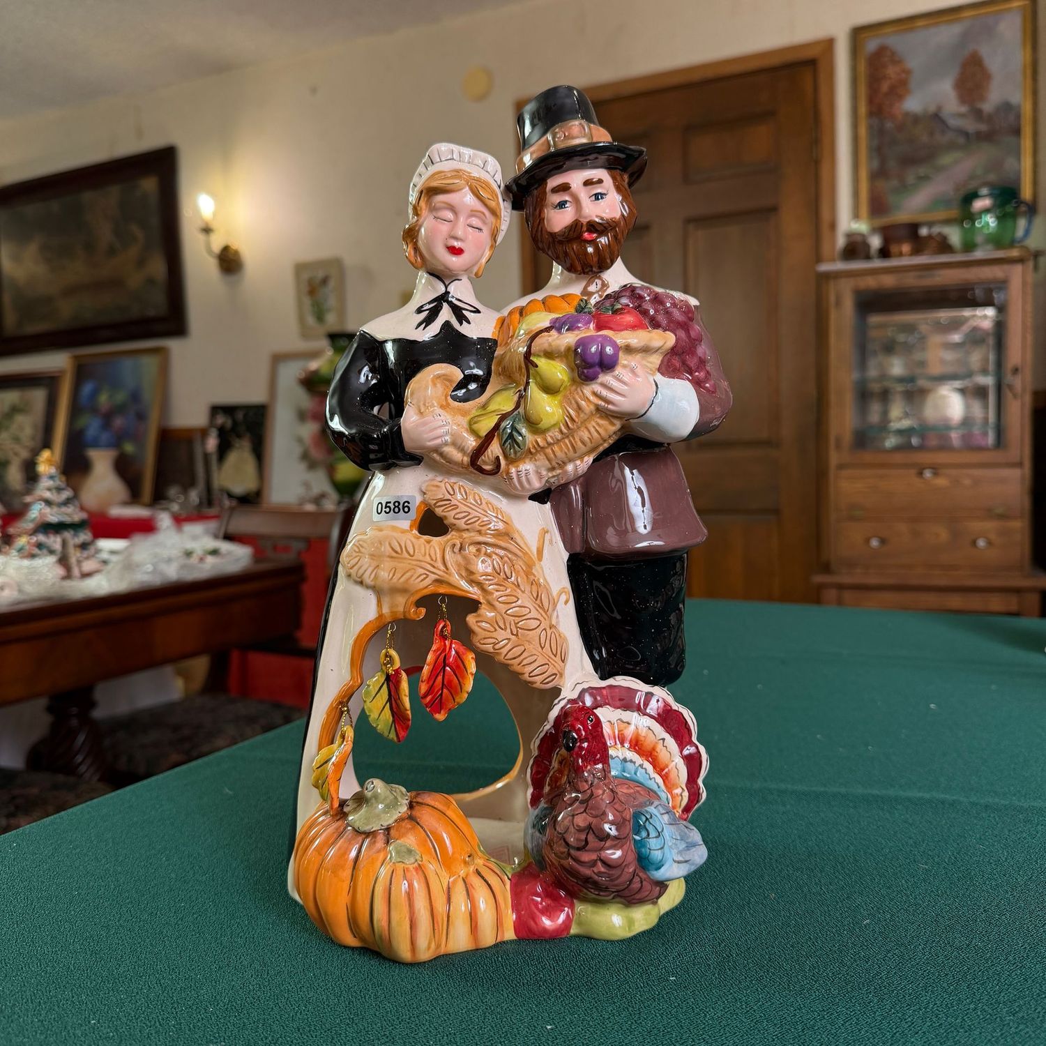 Blue Sky Clayworks Pilgrim couple with turkey and cornucopia, minor chip to a dangling leaf, 13 Blue Sky Clayworks Pilgrim couple with turkey and cornucopia, minor chip to a dangling leaf, 13"H, S0586