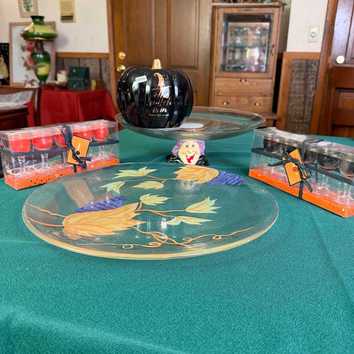 Halloween table display with cordial glass candles, 15" glass fall platter, glass dessert dish with witch base, and black witch is in ceramic pumpkin, S0568