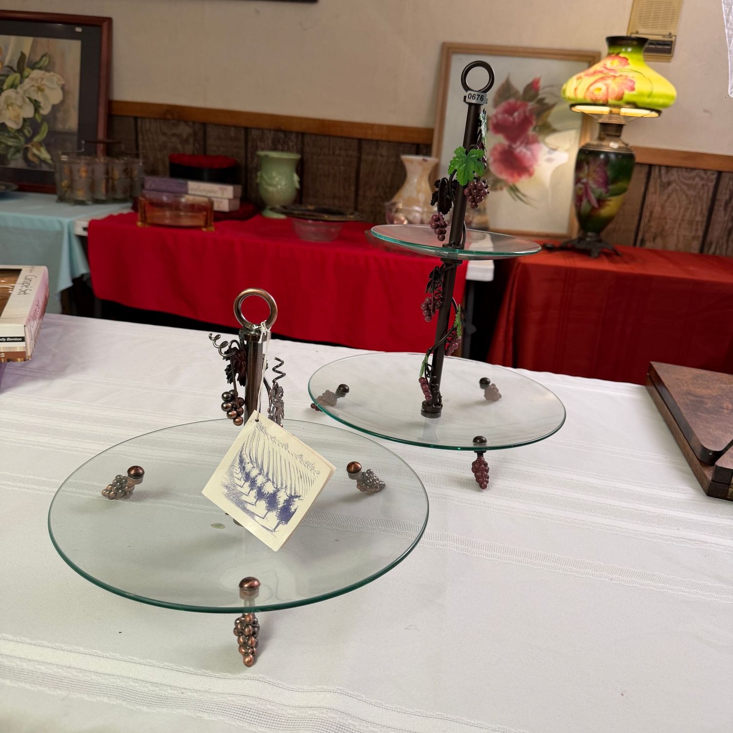 Two serving, tidbit stands with glass plates, metal grapes feet and vines, the tallest is 16 Two serving, tidbit stands with glass plates, metal grapes feet and vines, the tallest is 16"H x 12"W, S0676