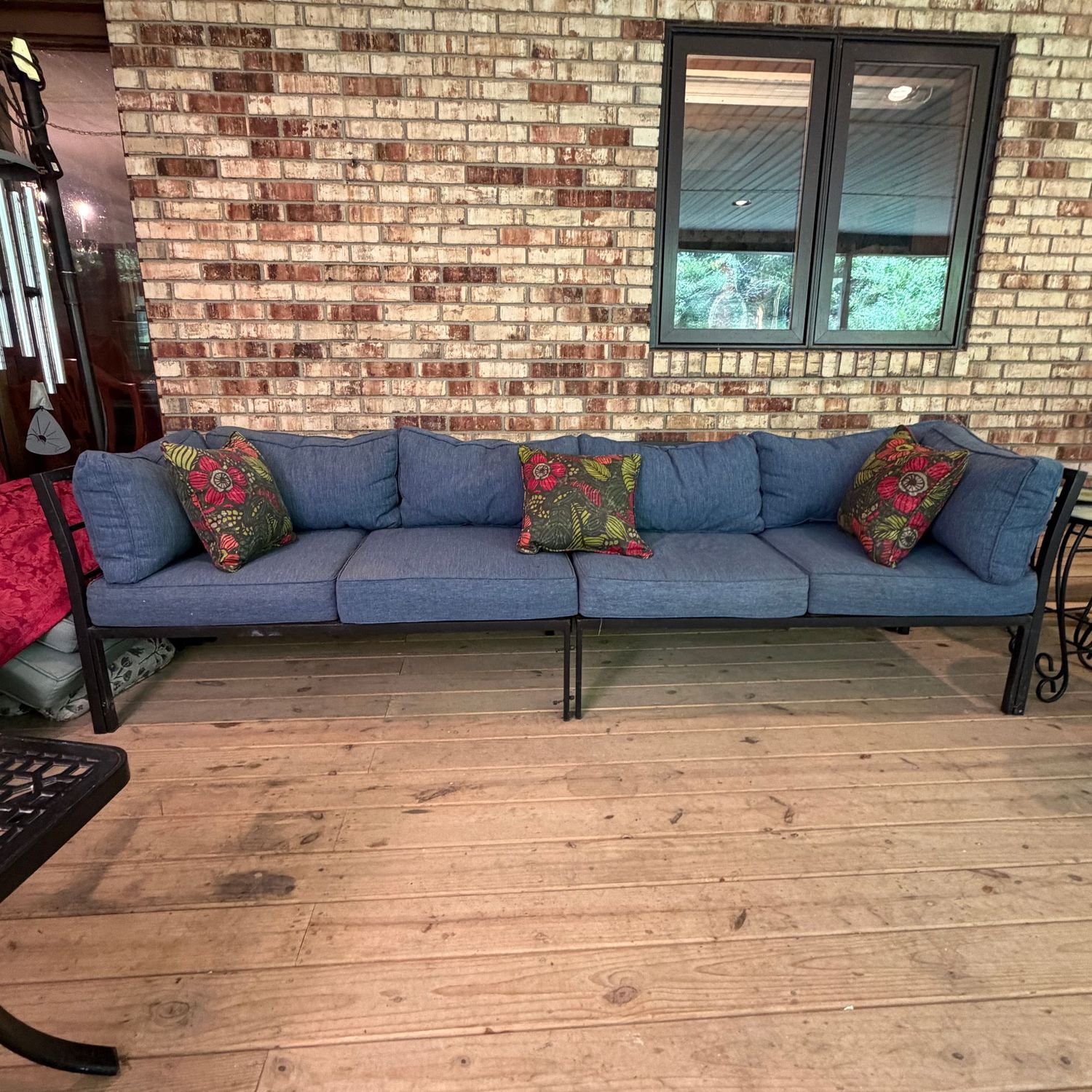 Two-piece long patio sofa with comfortable cushions and tropical accent pillows, overall in nice condition, has a few wear spots, 28 Two-piece long patio sofa with comfortable cushions and tropical accent pillows, overall in nice condition, has a few wear spots, 28"H x 28"D, and each section is 52"L, S0909