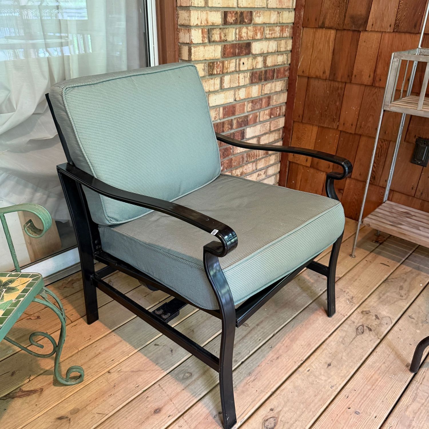 Black tubular patio chair, nice condition, seat has a light rocking mechanism, thick cushions, 30 Black tubular patio chair, nice condition, seat has a light rocking mechanism, thick cushions, 30"H x 25"W x 26"D, S0921