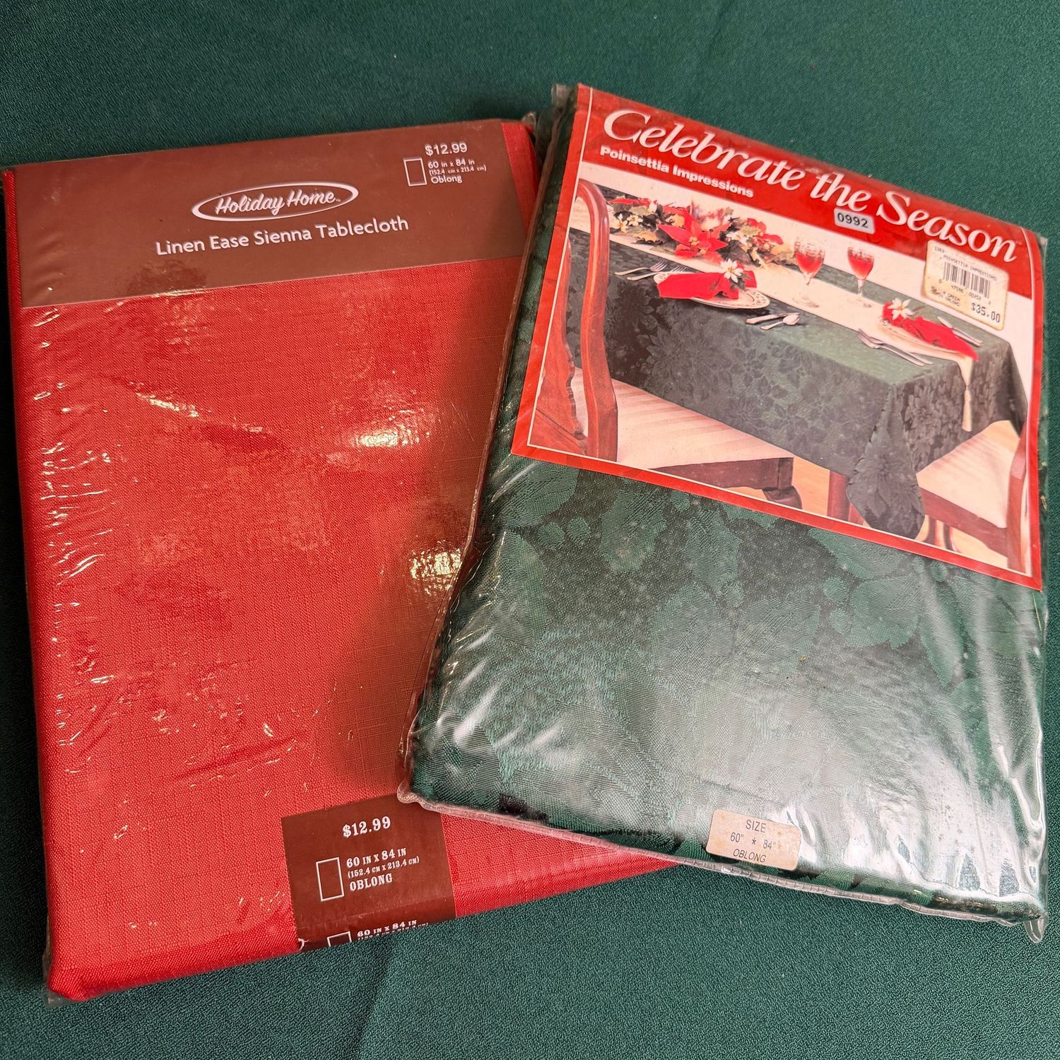 Two holiday tablecloths, green and red, in package, 60 Two holiday tablecloths, green and red, in package, 60" x 84", S0992