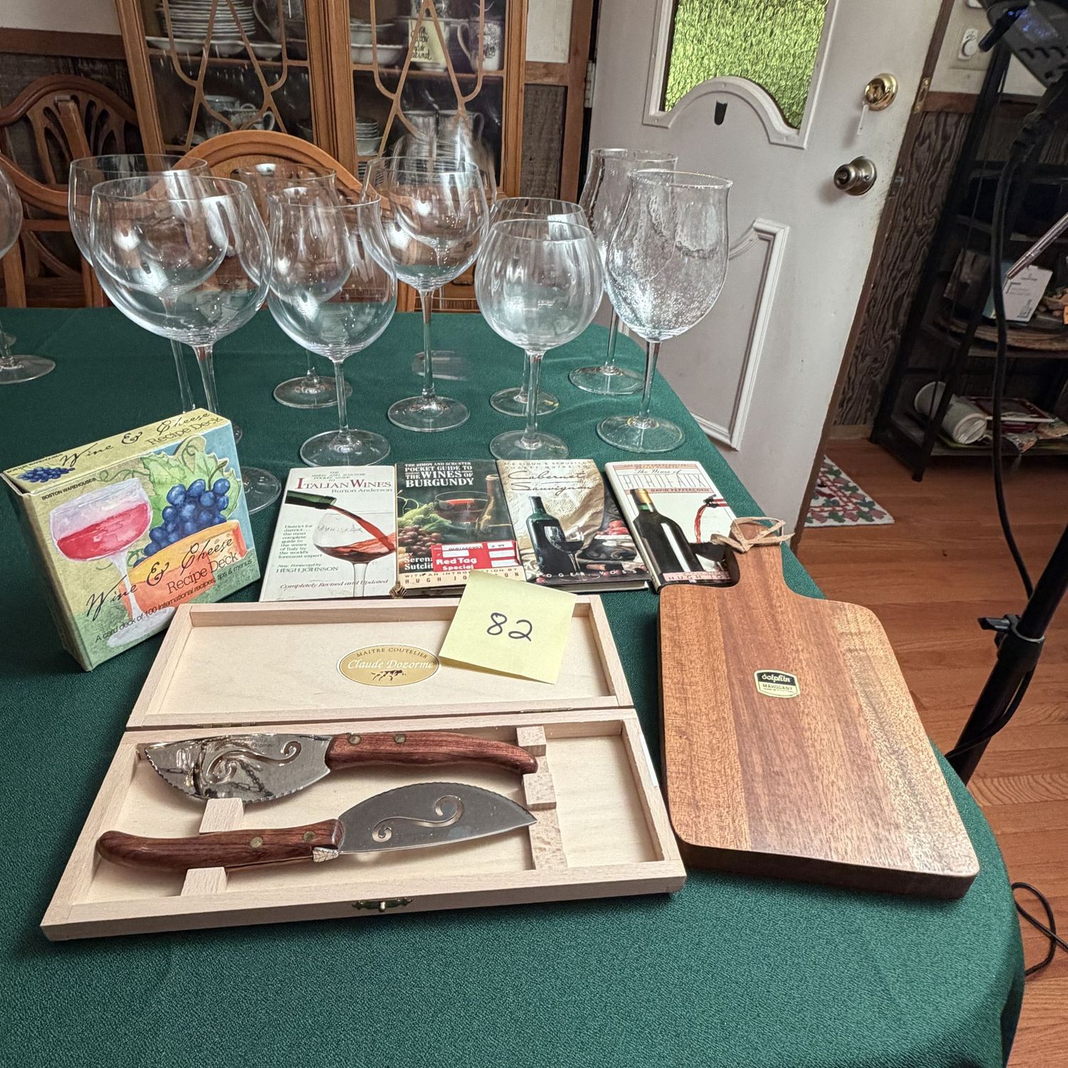 Box Lot (Wrapped) 82, barware guides, 9 crystal stemware wine glasses in a variety of wide-bowl sizes, mahogany charcuterie board, serving knife set