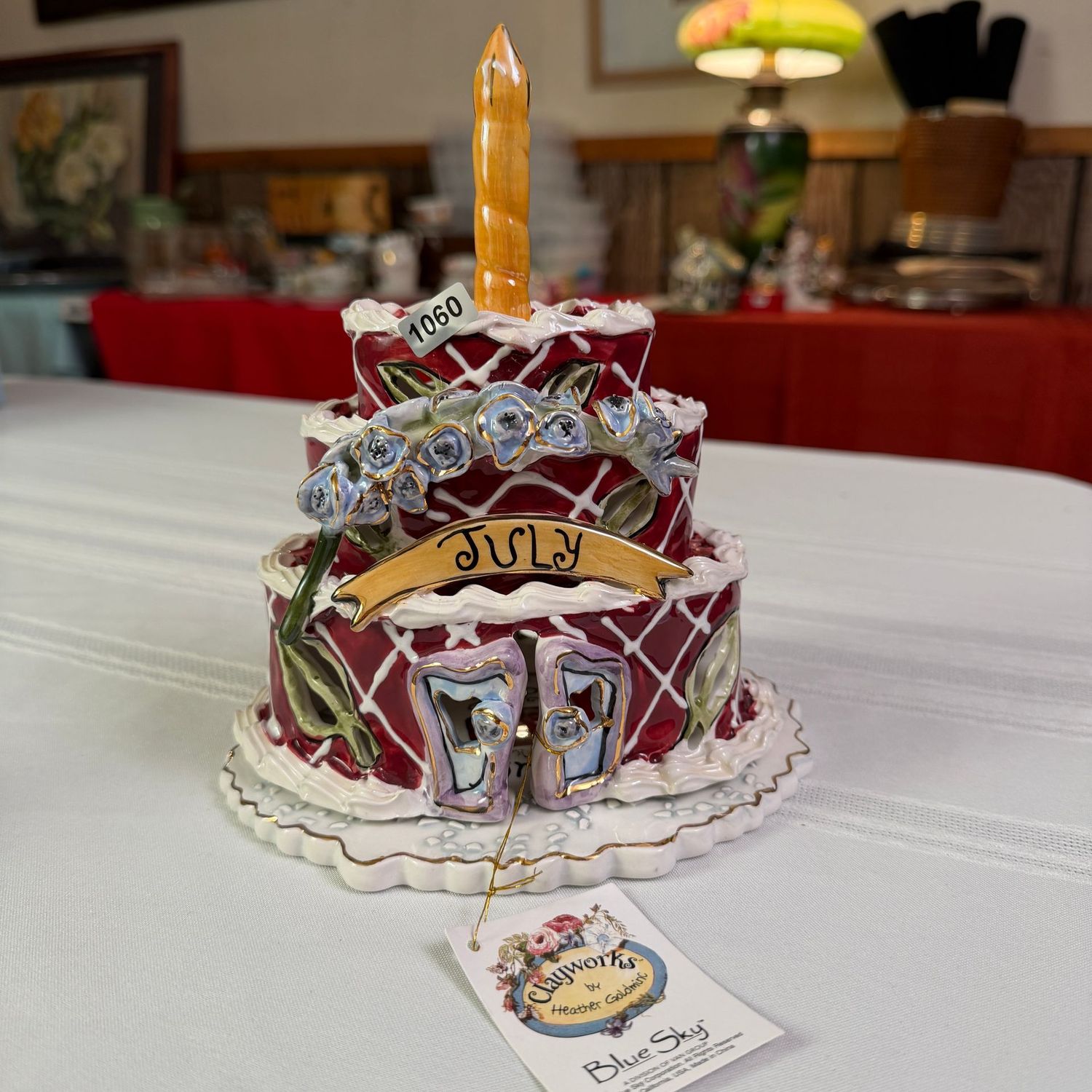 Blue Sky Clayworks S1060, July birthday cake with candle and underplate, 8 Blue Sky Clayworks S1060, July birthday cake with candle and underplate, 8"H