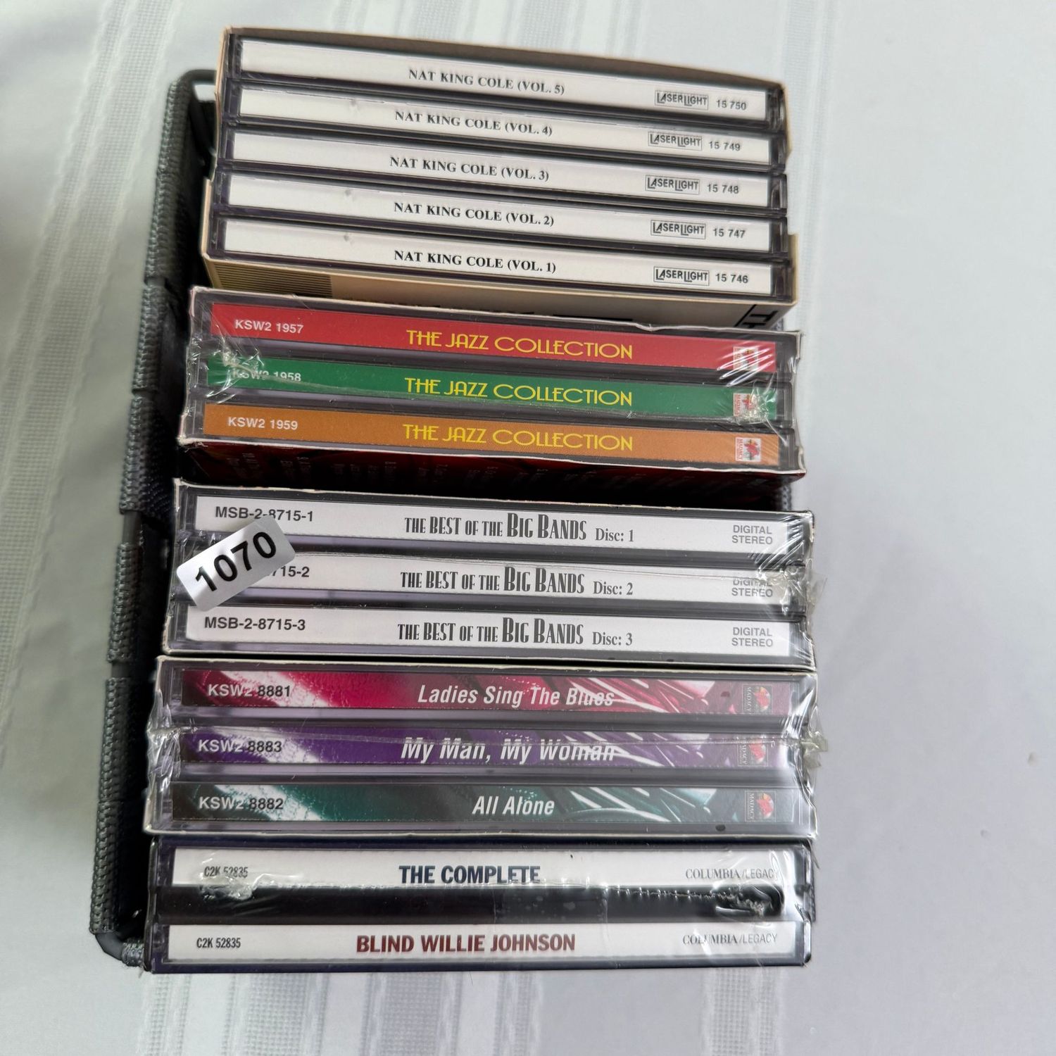 Small woven bin of CDs, Nat King Cole, Jazz, Big Bands, most unopened, S1070 Small woven bin of CDs, Nat King Cole, Jazz, Big Bands, most unopened, S1070