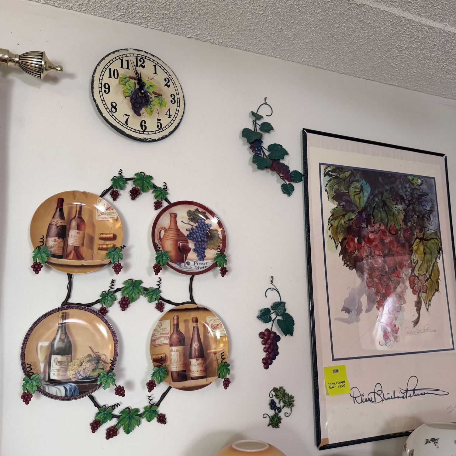Winery-themed wall display of metal vining grapes, plate display, clock, and signed 36 Winery-themed wall display of metal vining grapes, plate display, clock, and signed 36" x 24" poster, S1128