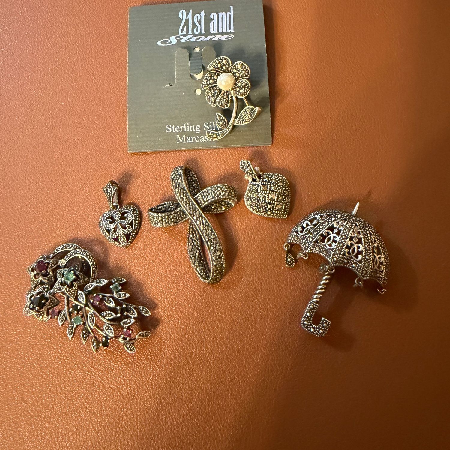 Sterling silver and Marcasite floral and umbrella brooches, three pendants, longest is 1.5 Sterling silver and Marcasite floral and umbrella brooches, three pendants, longest is 1.5", R0138