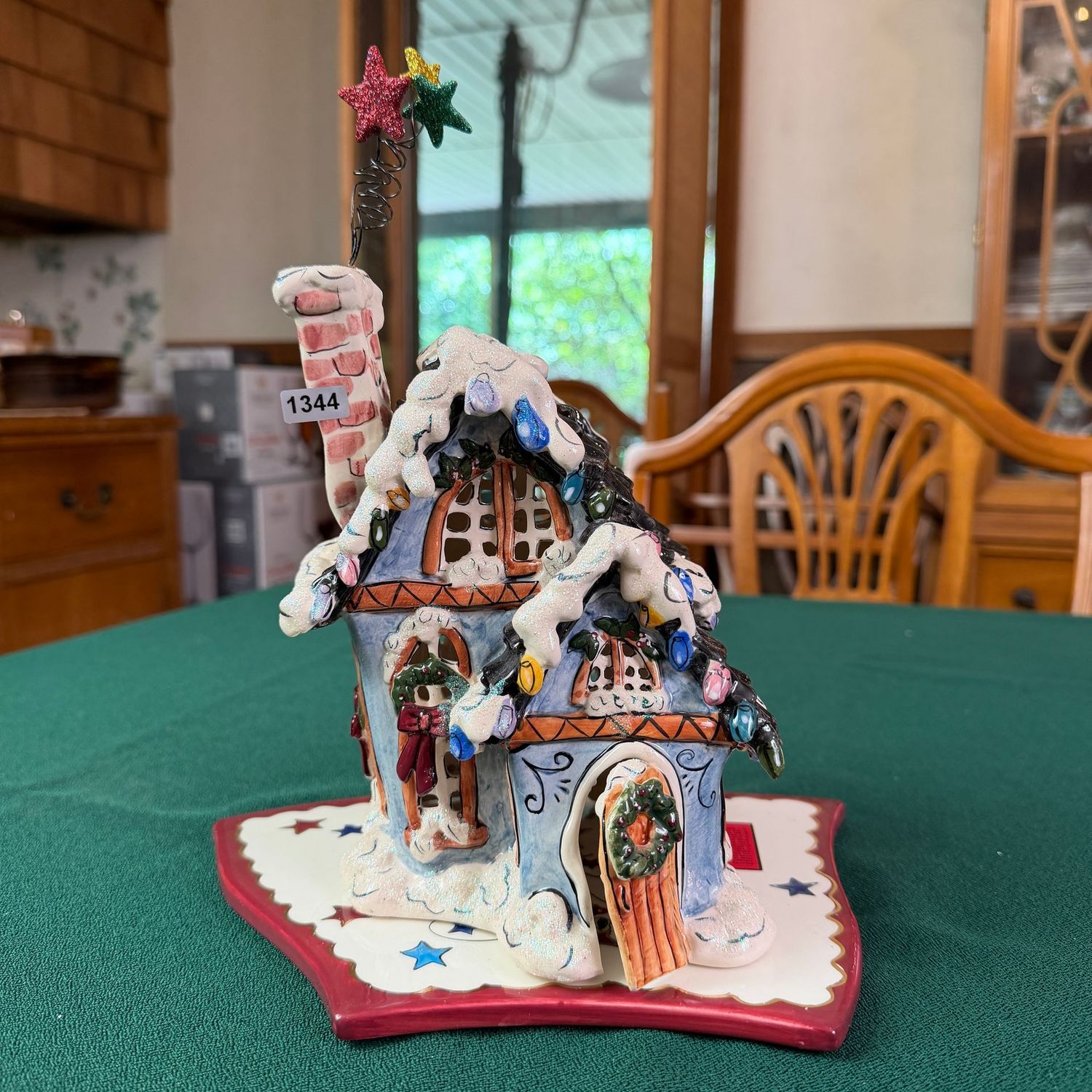 Blue Sky S1344 house with Christmas lights and glittered stars above the chimney, 10 Blue Sky S1344 house with Christmas lights and glittered stars above the chimney, 10"H