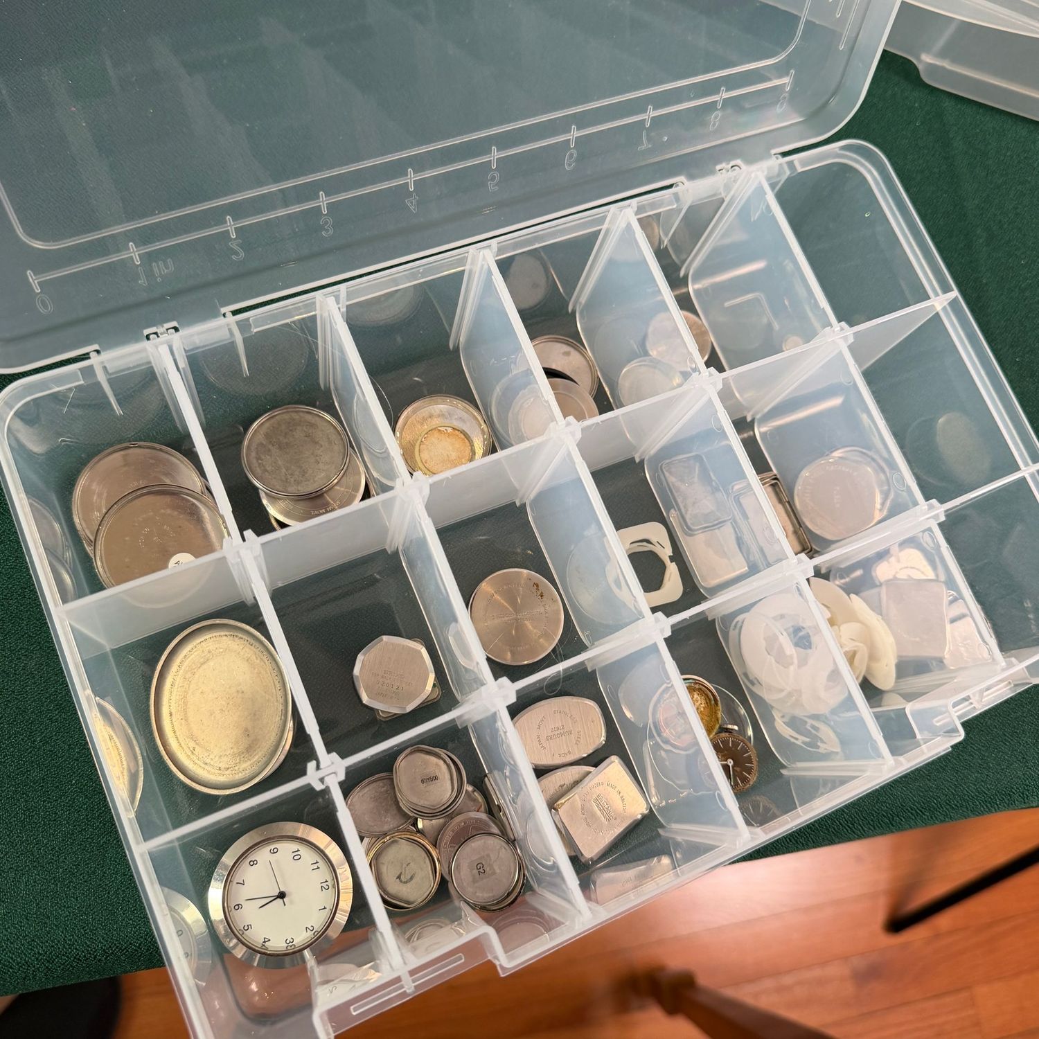 Plastic organizer with watch parts, mostly backs, R0205 Plastic organizer with watch parts, mostly backs, R0205