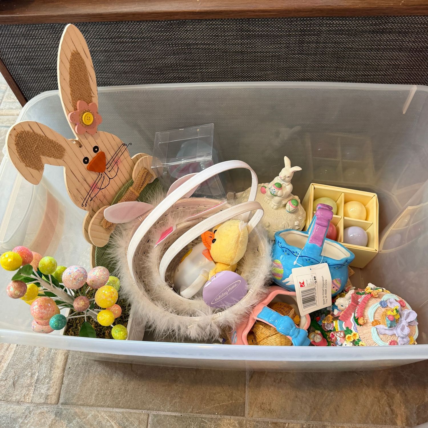 Clear bin filled with Easter decor, glittered egg tree, woven and ceramic baskets, music box, ceramic eggs & more, S1673 Clear bin filled with Easter decor, glittered egg tree, woven and ceramic baskets, music box, ceramic eggs & more, S1673