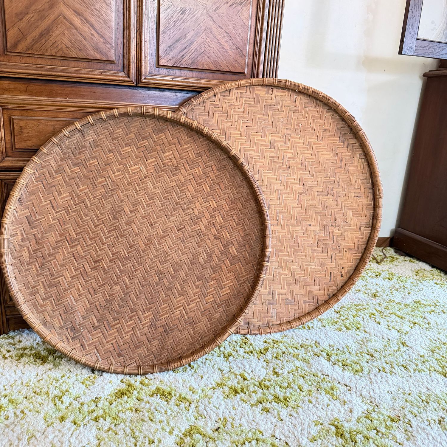 Two large woven bamboo winnowing trays, the largest is 30 Two large woven bamboo winnowing trays, the largest is 30"W