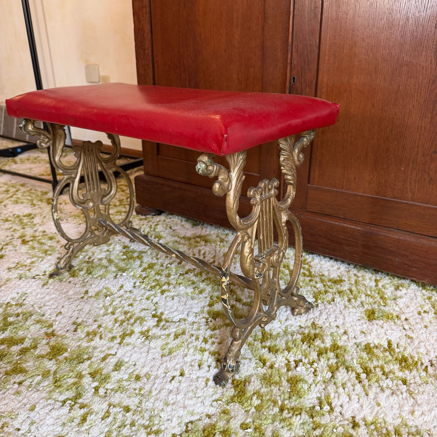 Piano/vanity bench with red vinyl seat and cast iron lyre legs, ca 1920, 14 Piano/vanity bench with red vinyl seat and cast iron lyre legs, ca 1920, 14"H x 23"L x 11"D