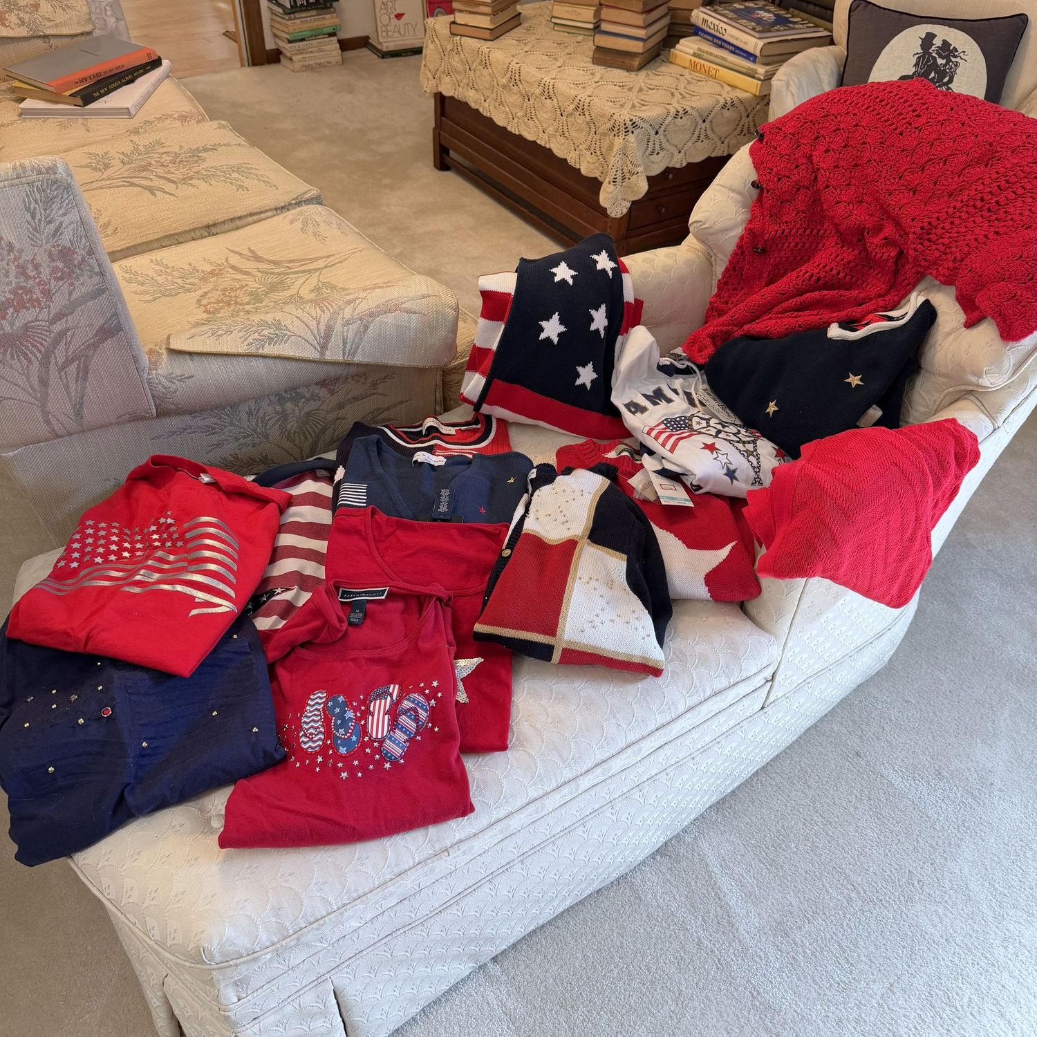 Variety of patriotic t-shirts, vests, and sweaters, most are women's L/XL