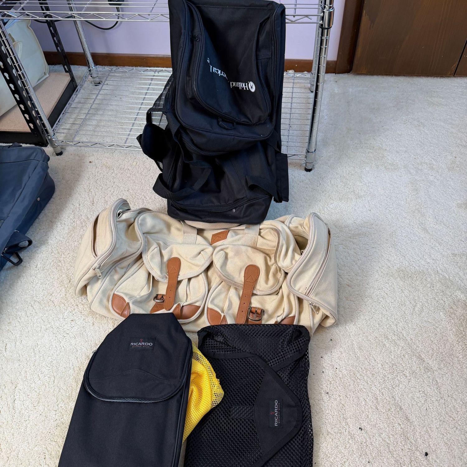 Black rolling duffel bag with tan canvas duffel (22 Black rolling duffel bag with tan canvas duffel (22"W) and Ricardo luggage inserts
