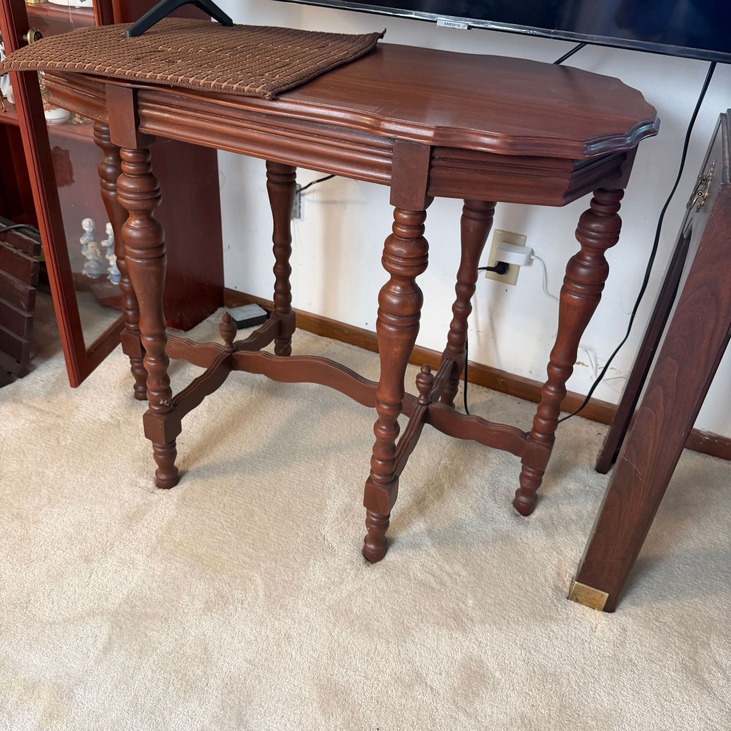 Vintage tall occasional table with scalloped edge, turned legs supported by an H-stretcher with finials, good condition, minor scratches, 28"H x 36"L x 21"D (This item is upstairs)