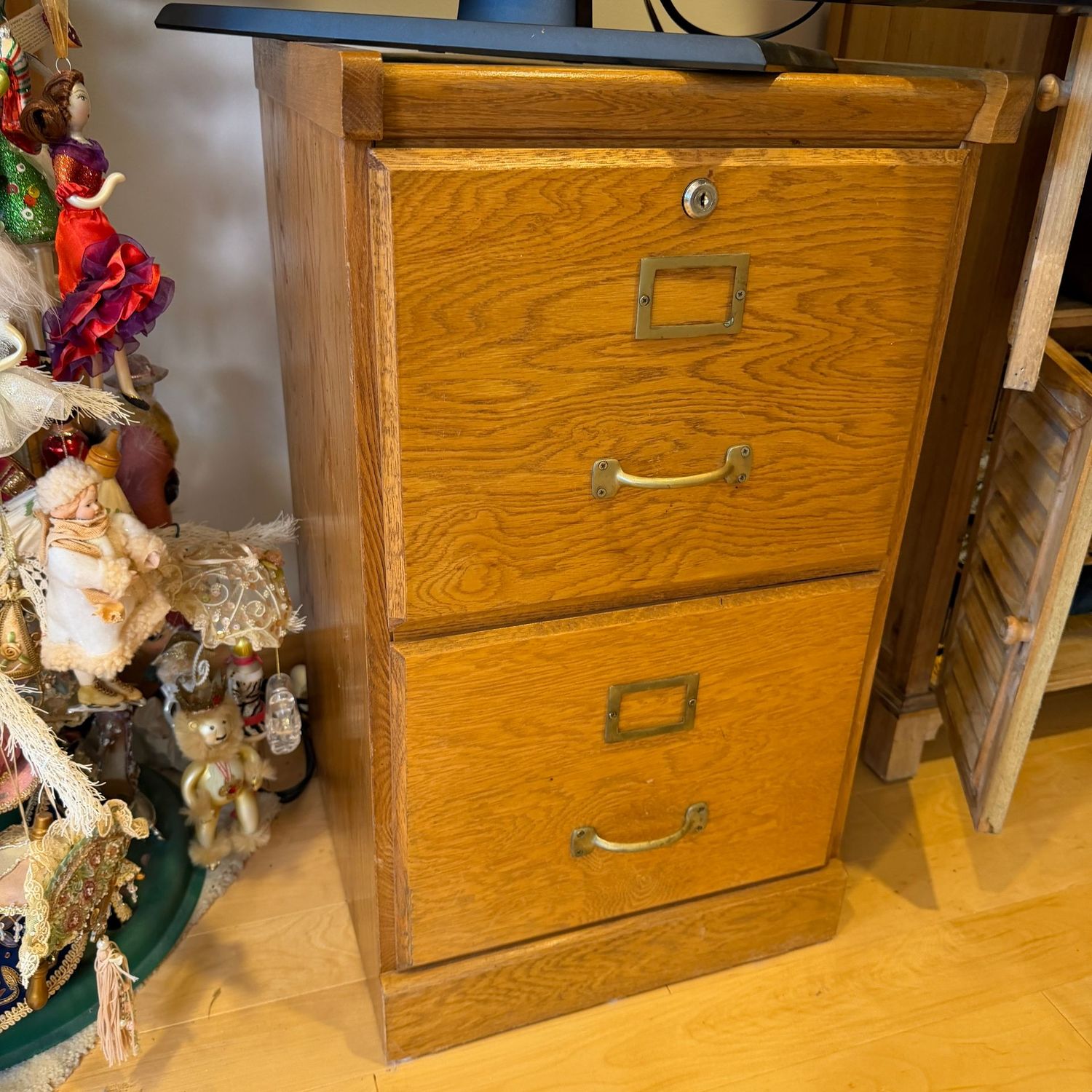 Two-drawer wooden file cabinet, no key, overall good condition, 28 Two-drawer wooden file cabinet, no key, overall good condition, 28"H x 16"W x 16"D, this item is upstairs