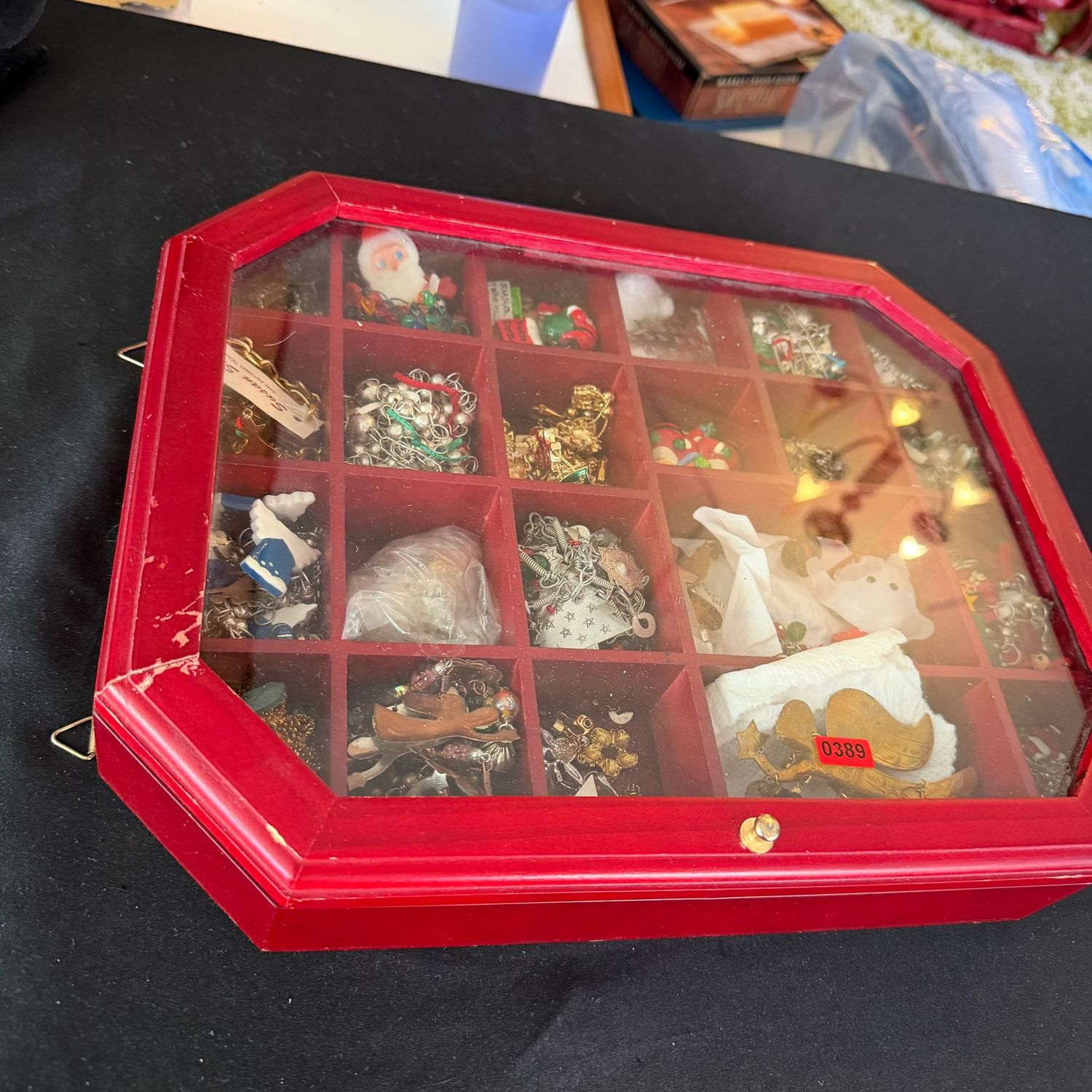 Jewelry lot R0389 red miniature display case (some wear) 14 Jewelry lot R0389 red miniature display case (some wear) 14"L x 12"W filled with costume Christmas-themed jewelry